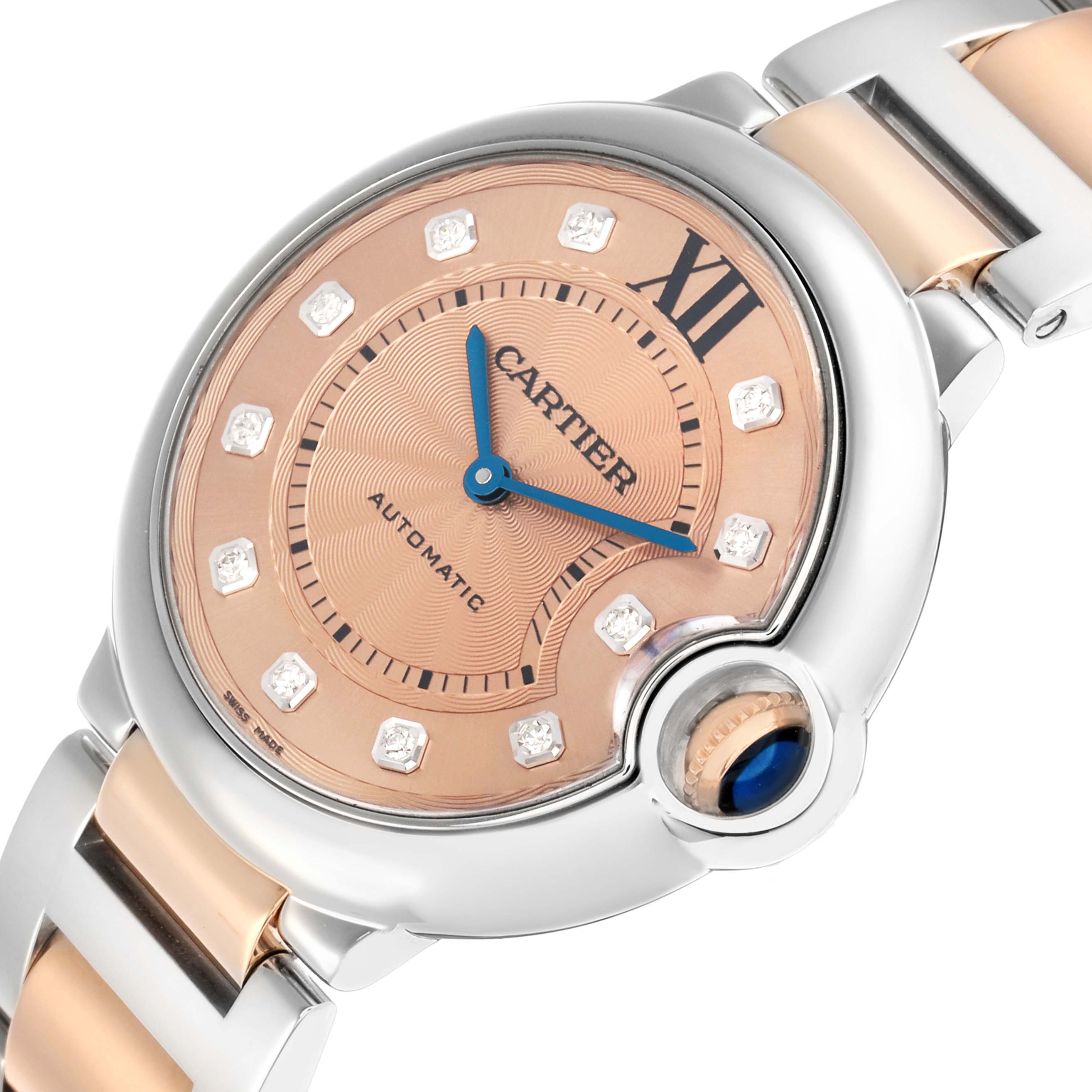 The Cartier Ballon Bleu WE902054 Women's Steel and Gold (two tone) Pink Dial watch is shown at a tilted angle, highlighting the face, crown, and part of the bracelet.
