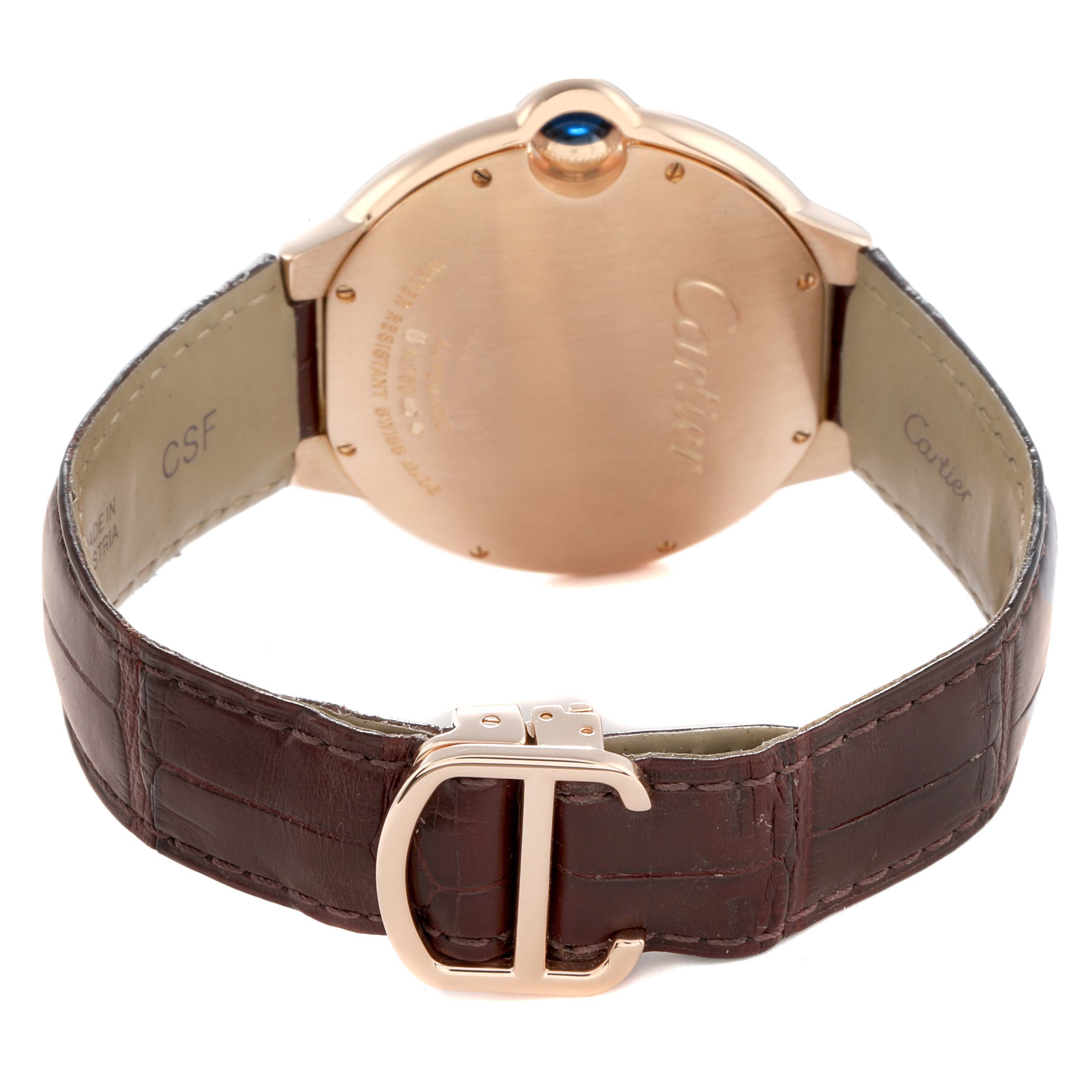 The Cartier Ballon Bleu WGBB0017 Men
s Rose Gold Silver Dial watch is shown from the back, highlighting the case, brown leather strap, and distinctive clasp.