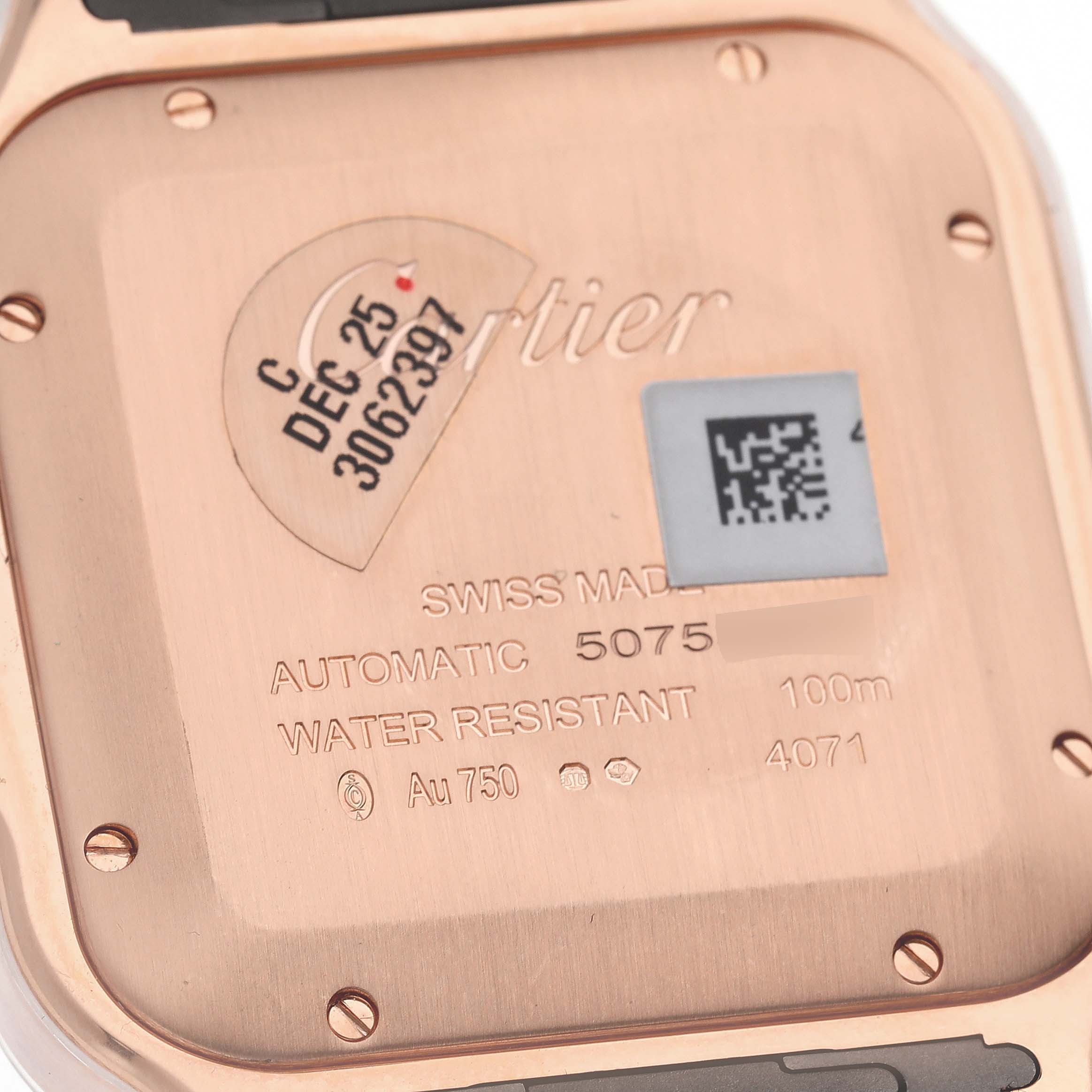 The image shows the case back of a Cartier Santos WGSA0019 Men's Rose Gold Silver Dial WGSA0019 Men's Rose Gold Silver Dial watch, displaying details like the serial number, water resistance, and material.