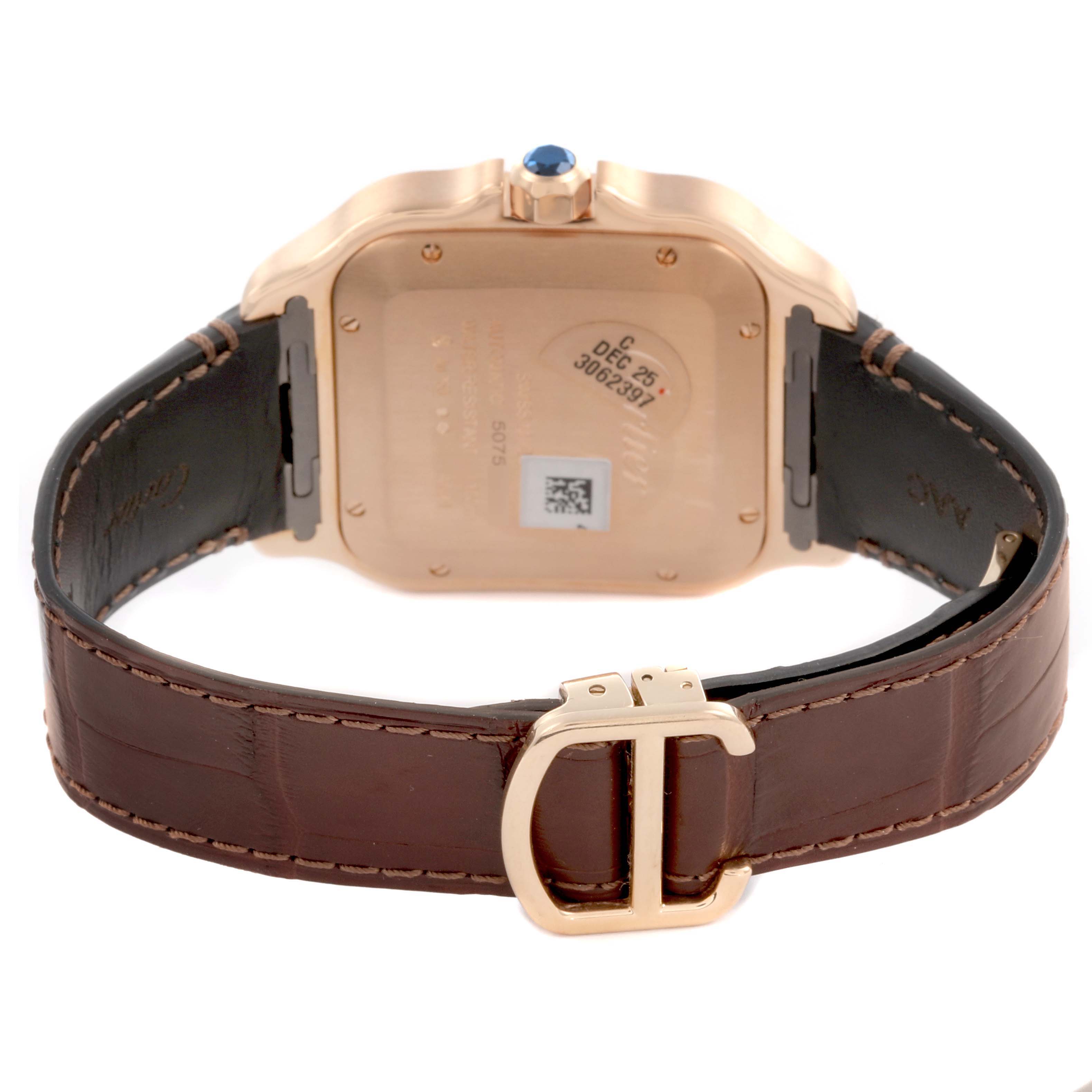 The image shows the back of the Cartier Santos WGSA0019 Men's Rose Gold Silver Dial WGSA0019 Men's Rose Gold Silver Dial watch and its brown leather strap with a gold buckle.