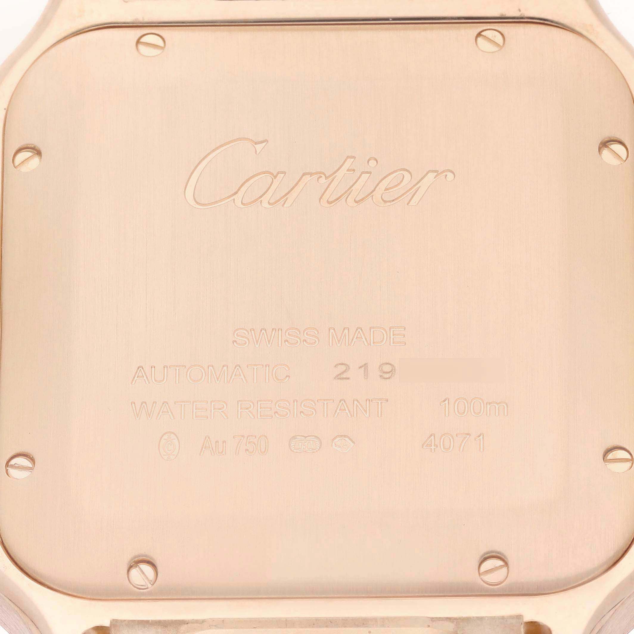 The image shows the back case of a Cartier Santos WGSA0018 Men's Rose Gold Silver Dial watch with engravings detailing its specifications and branding.