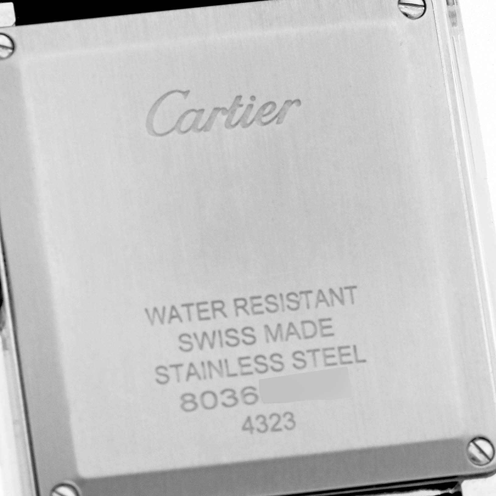 The image shows the stainless steel case back of a Cartier Tank Must WSTA0041 Women
s Stainless Steel Silver Dial WSTA0041 Women
s Stainless Steel Silver Dial watch, highlighting its engravings.