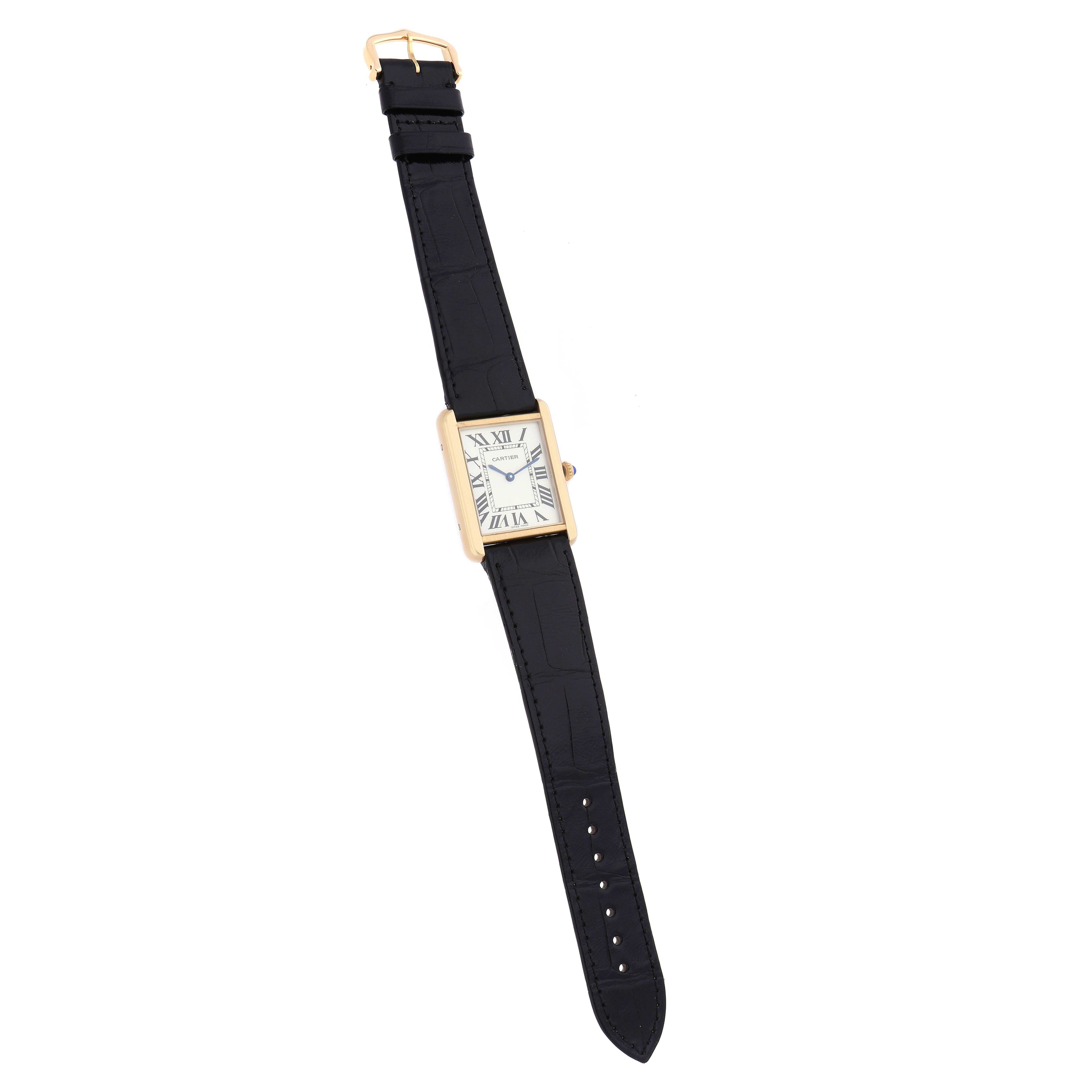 The Cartier Tank Solo W5200004 Men
s Steel and Gold (two tone) Silver Dial watch is shown from above, displaying its rectangular face, black strap, and gold buckle.