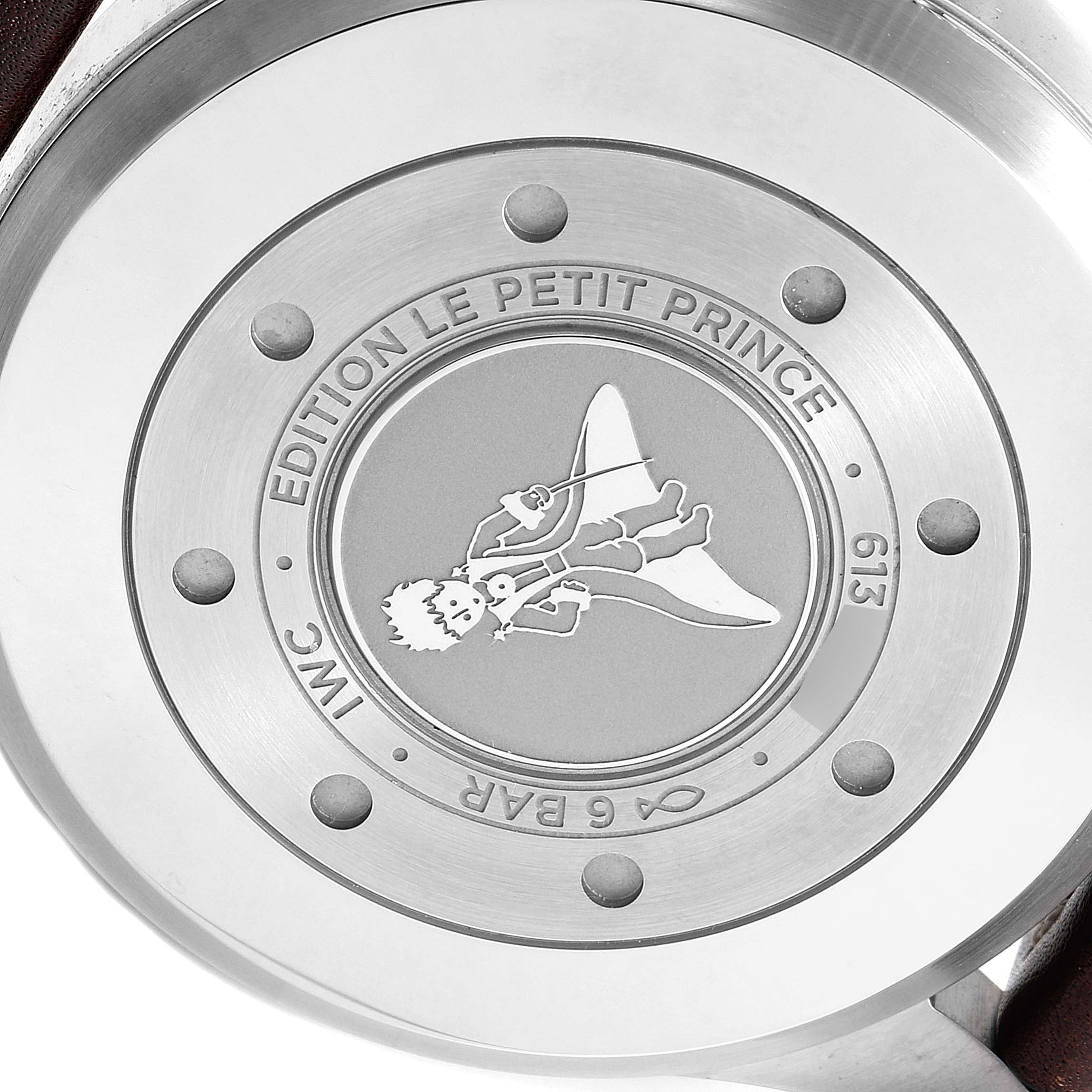 This image shows the case back of an IWC Pilot IW501002 Men's Stainless Steel Blue Dial IW501002 Men's Stainless Steel Blue Dial model "Edition Le Petit Prince" watch, featuring an engraved illustration.