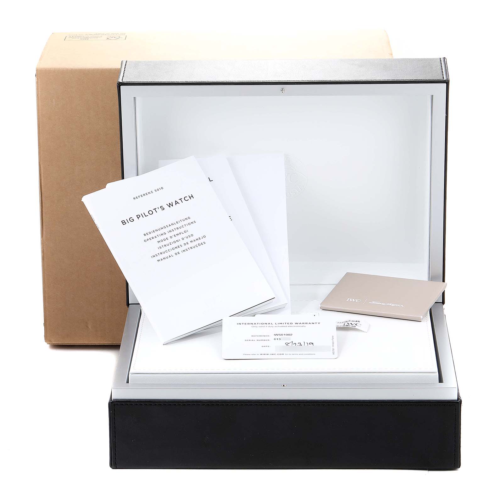 The image shows the packaging, manuals, and warranty card for an IWC Pilot IW501002 Men's Stainless Steel Blue Dial IW501002 Men's Stainless Steel Blue Dial model watch.