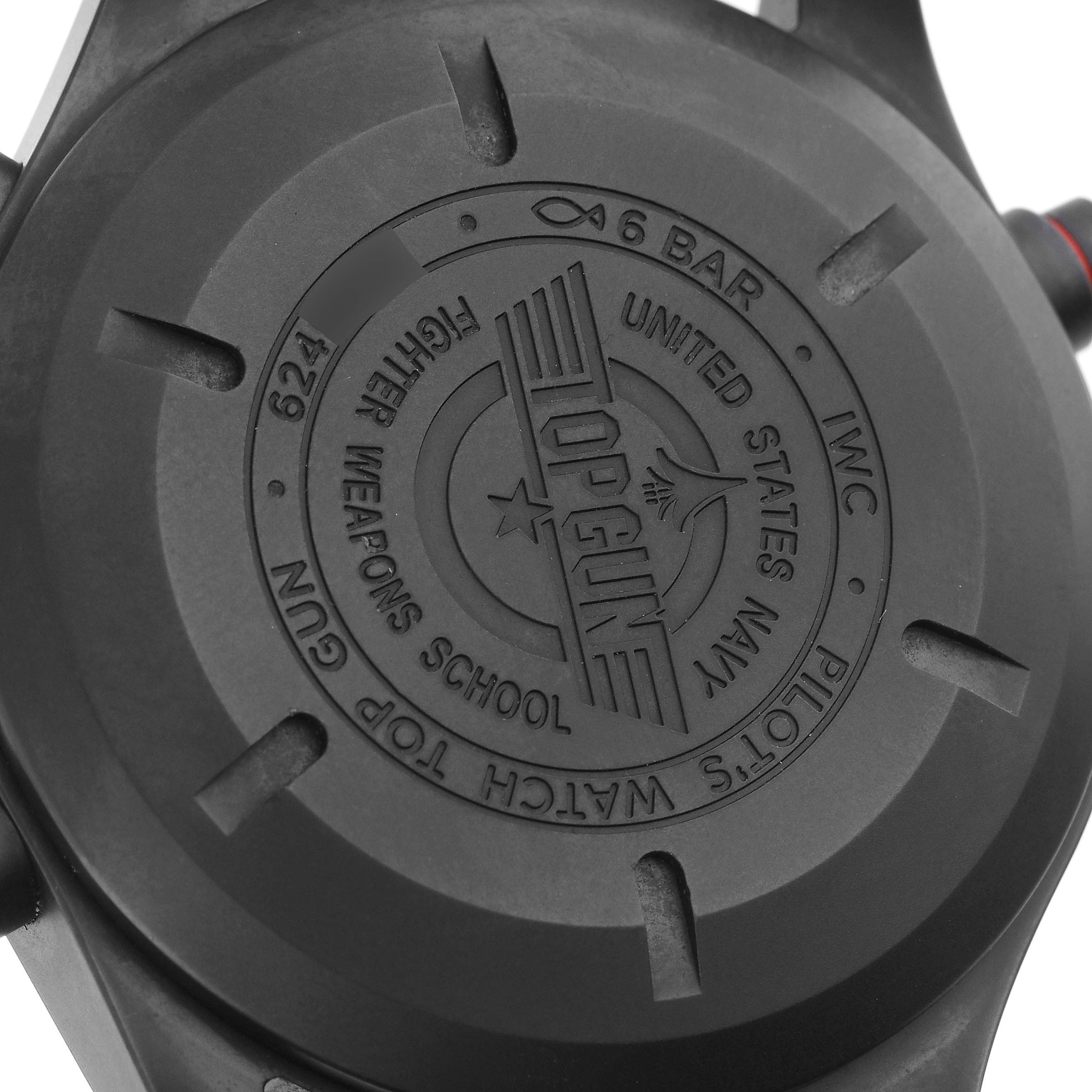 The image shows the back case of an IWC Pilot IW371815 Men
s Ceramic Black Dial IW371815 Men
s Ceramic Black Dial watch from a slightly angled view, featuring the "Top Gun" branding.