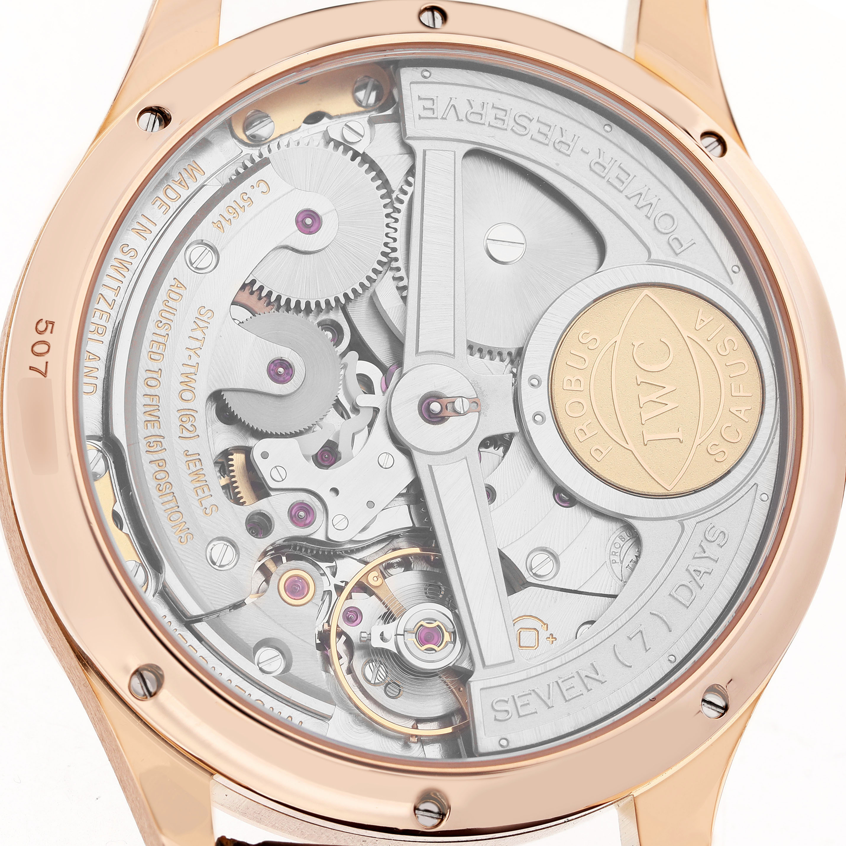 The image shows the back of an IWC Portuguese IW503202 Men's Rose Gold Black Dial watch, highlighting its intricate movement and power reserve details.