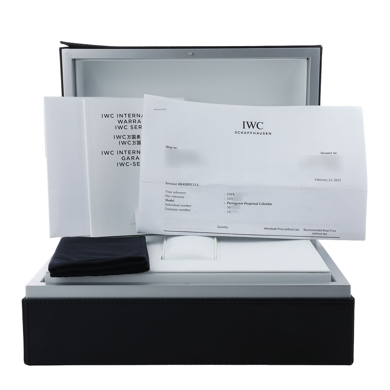 The image shows the packaging and documents for an IWC Portuguese IW503202 Men's Rose Gold Black Dial model, including warranty cards and a cleaning cloth.