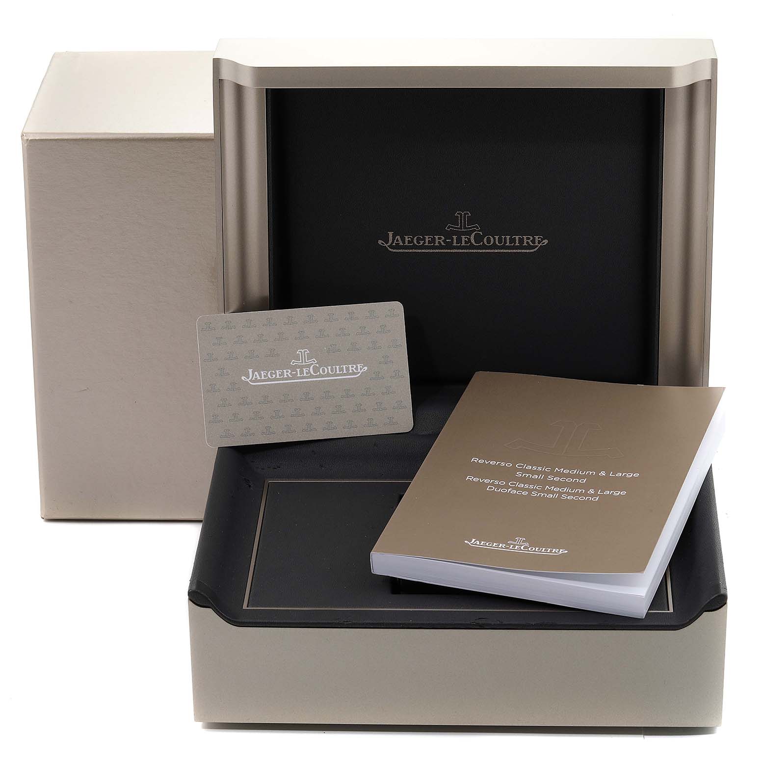 The image shows the Jaeger-LeCoultre Reverso watch box, a warranty card, and a manual from a front angle.