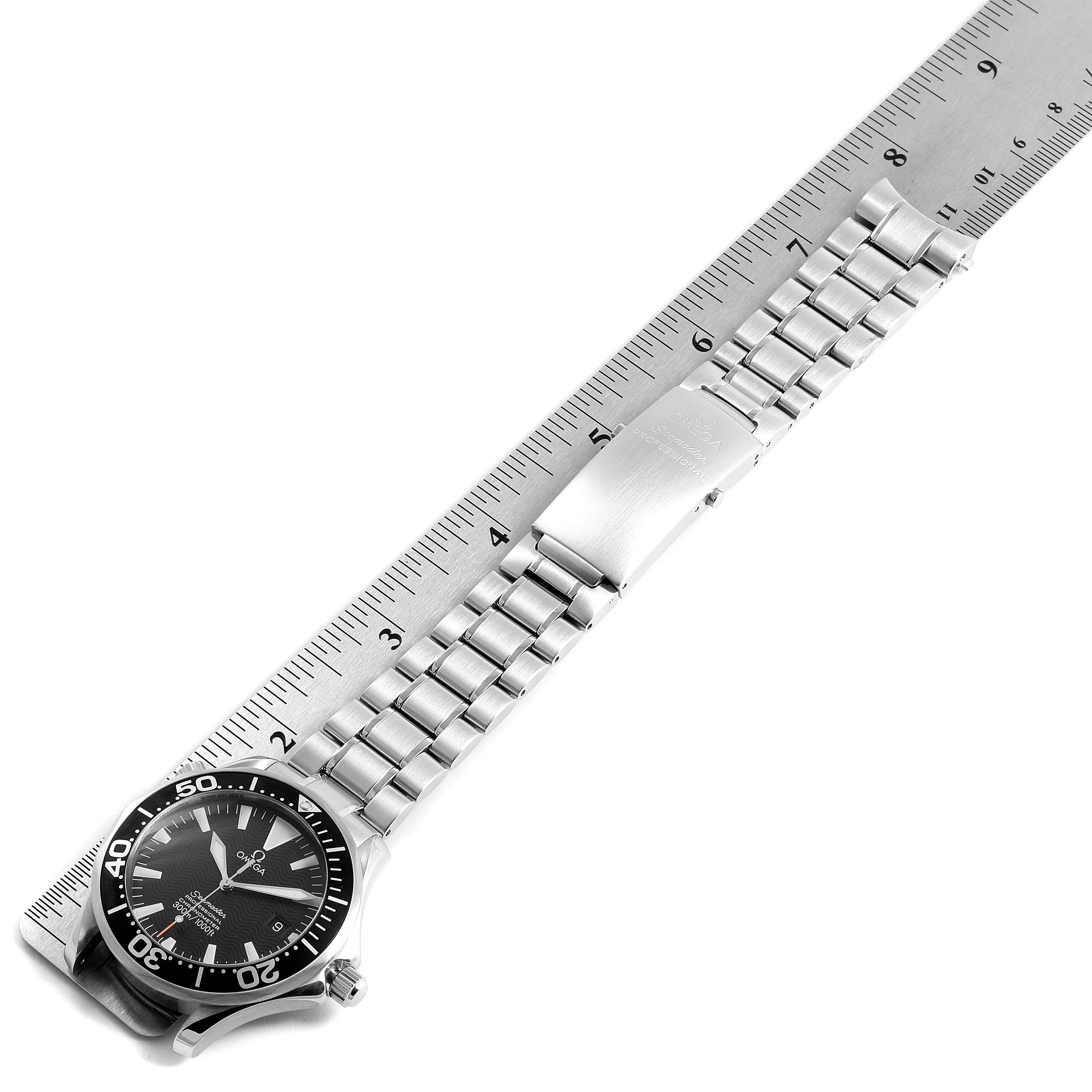 The image features an Omega Seamaster 2254.50.00 Men
s Stainless Steel Black Dial 2254.50.00 Men
s Stainless Steel Black Dial watch, showcasing its face, bezel, and metal bracelet with part of a ruler for scale.