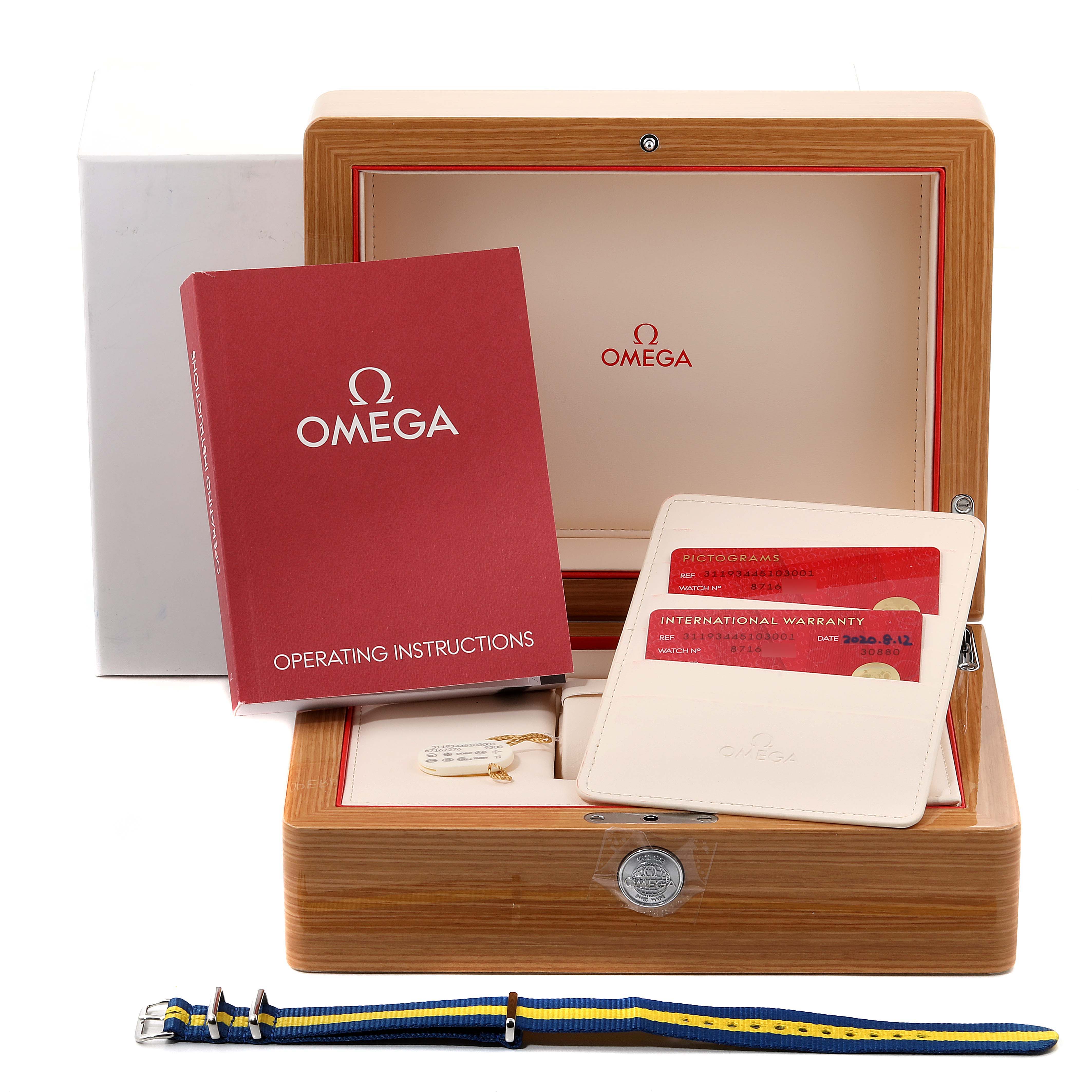 The image shows an Omega Speedmaster 311.93.44.51.03.001 Men's Stainless Steel Blue Dial 311.93.44.51.03.001 Men's Stainless Steel Blue Dial watch box, operating instructions, warranty cards, and an extra strap.