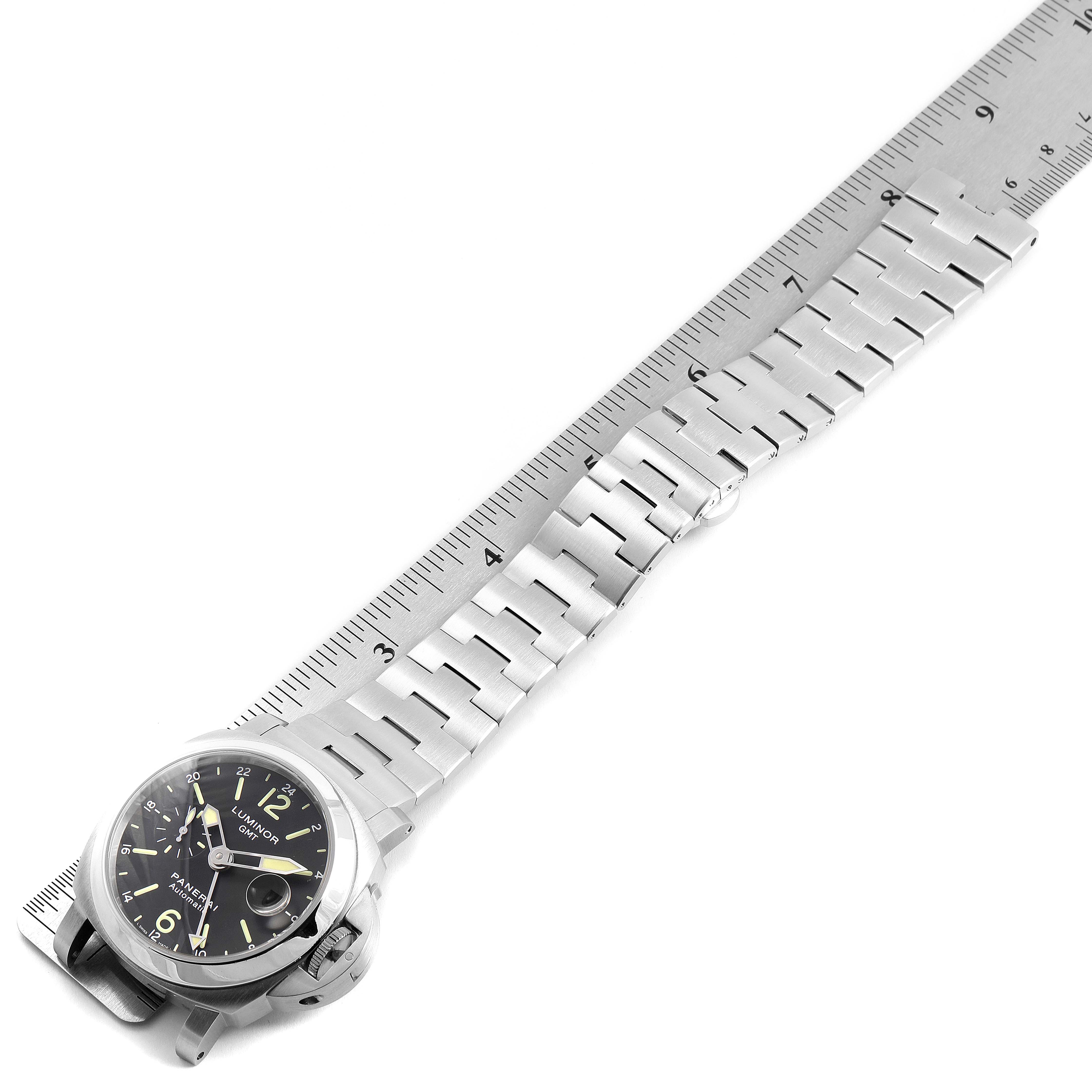 The image shows a Panerai Luminor PAM00297 Men
s Stainless Steel Black Dial PAM00297 Men
s Stainless Steel Black Dial watch laid on a ruler, displaying the watch face and metallic strap from a top-down angle.