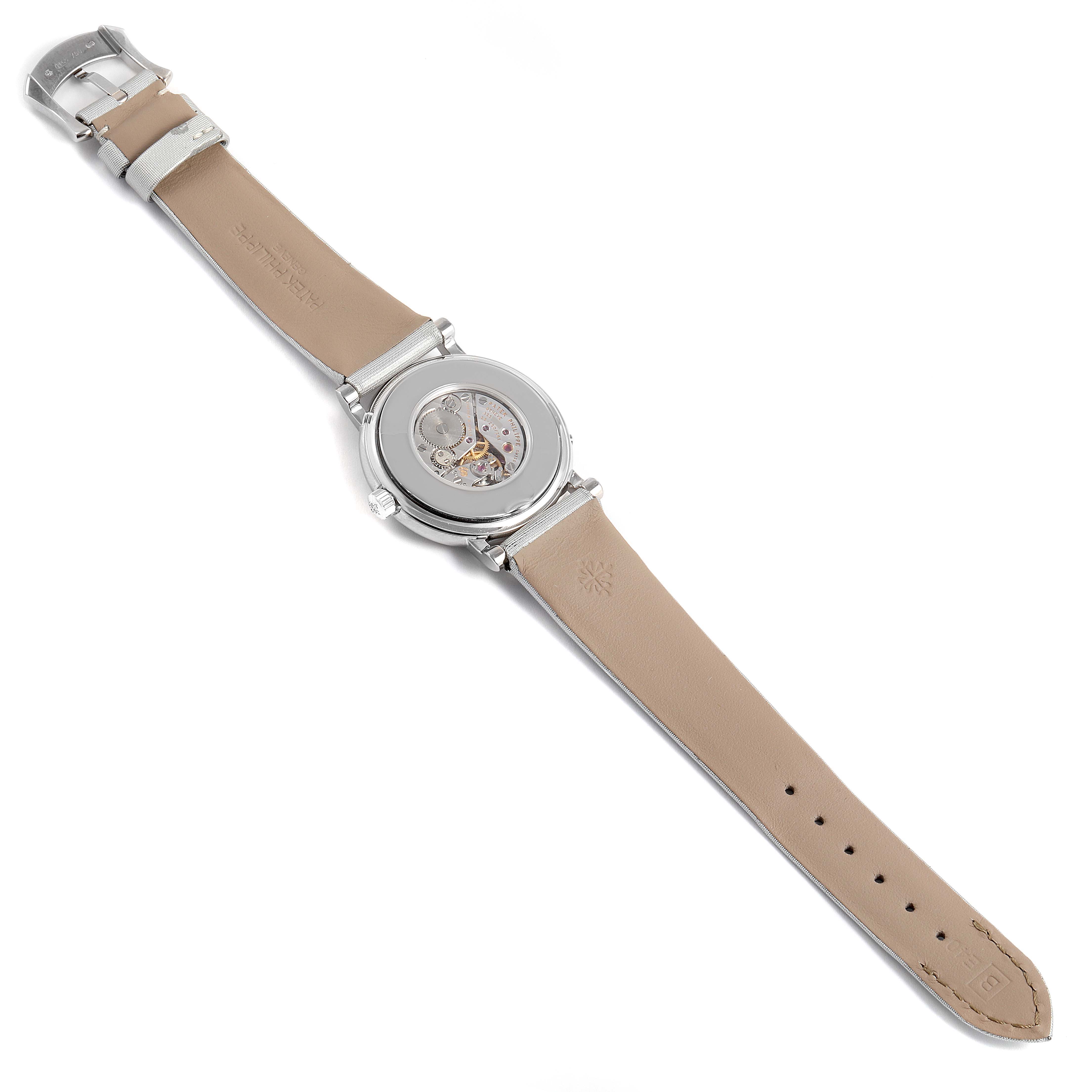 This is an overhead view of a Patek Philippe Calatrava 4958G Women's White Gold Mother of Pearl Dial 4958G Women's White Gold Mother of Pearl Dial watch showing the back of the case and the full leather strap laid flat.