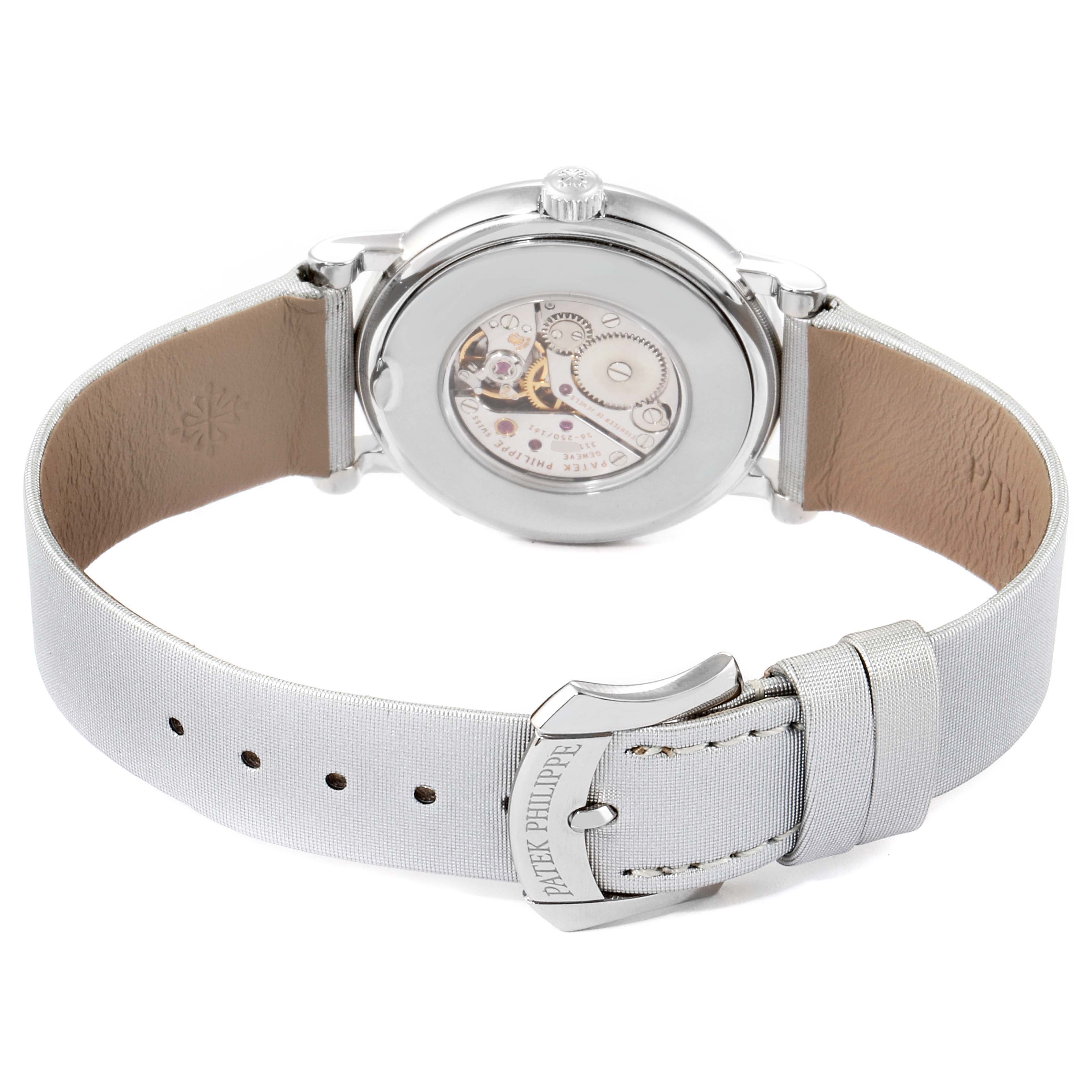 The image shows the back view of a Patek Philippe Calatrava 4958G Women's White Gold Mother of Pearl Dial 4958G Women's White Gold Mother of Pearl Dial watch, highlighting its movement and strap with branding on the buckle.