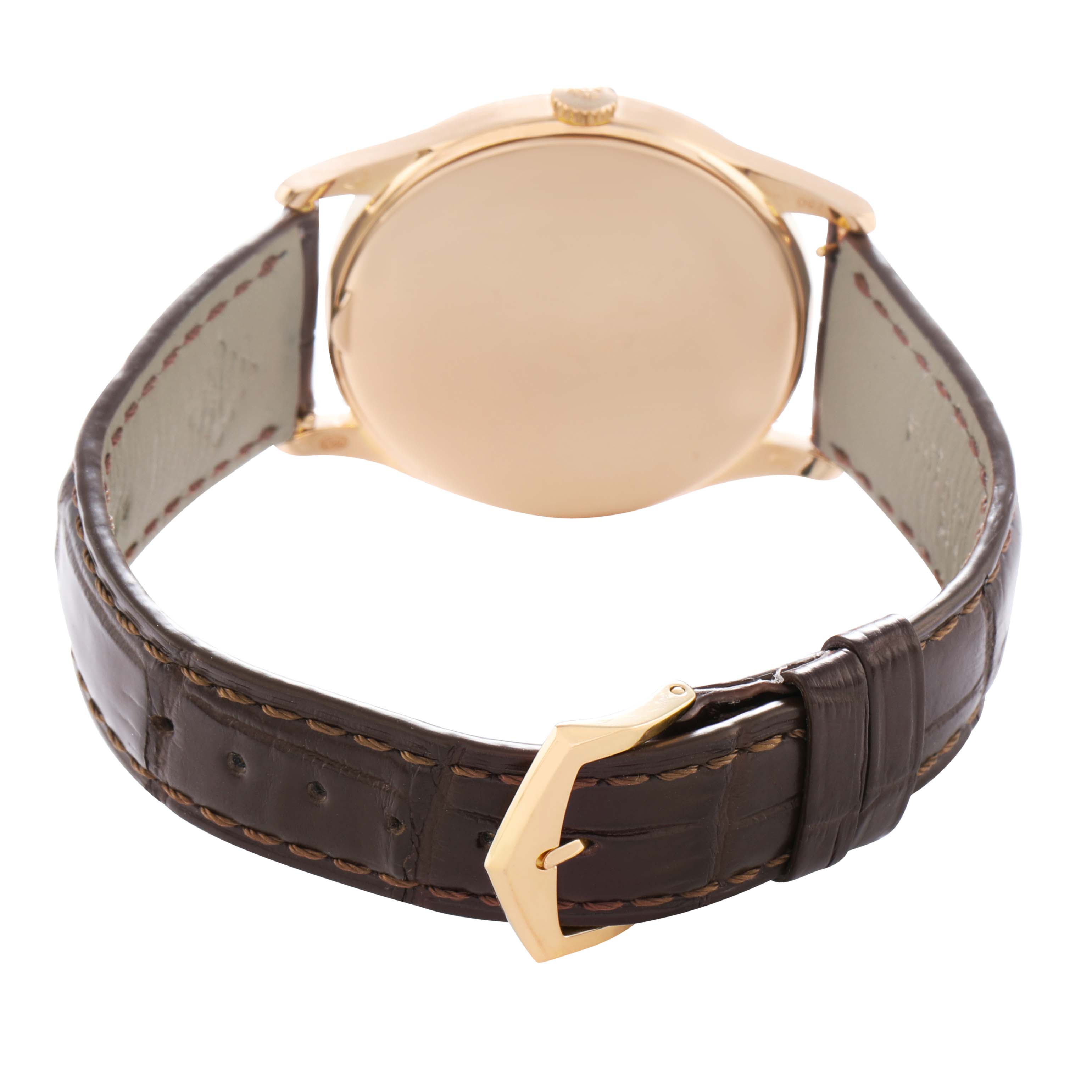 The image shows the back view of a Patek Philippe Calatrava 5196R Men
s Rose Gold Silver Dial watch, highlighting its gold case, brown leather strap, and buckle.