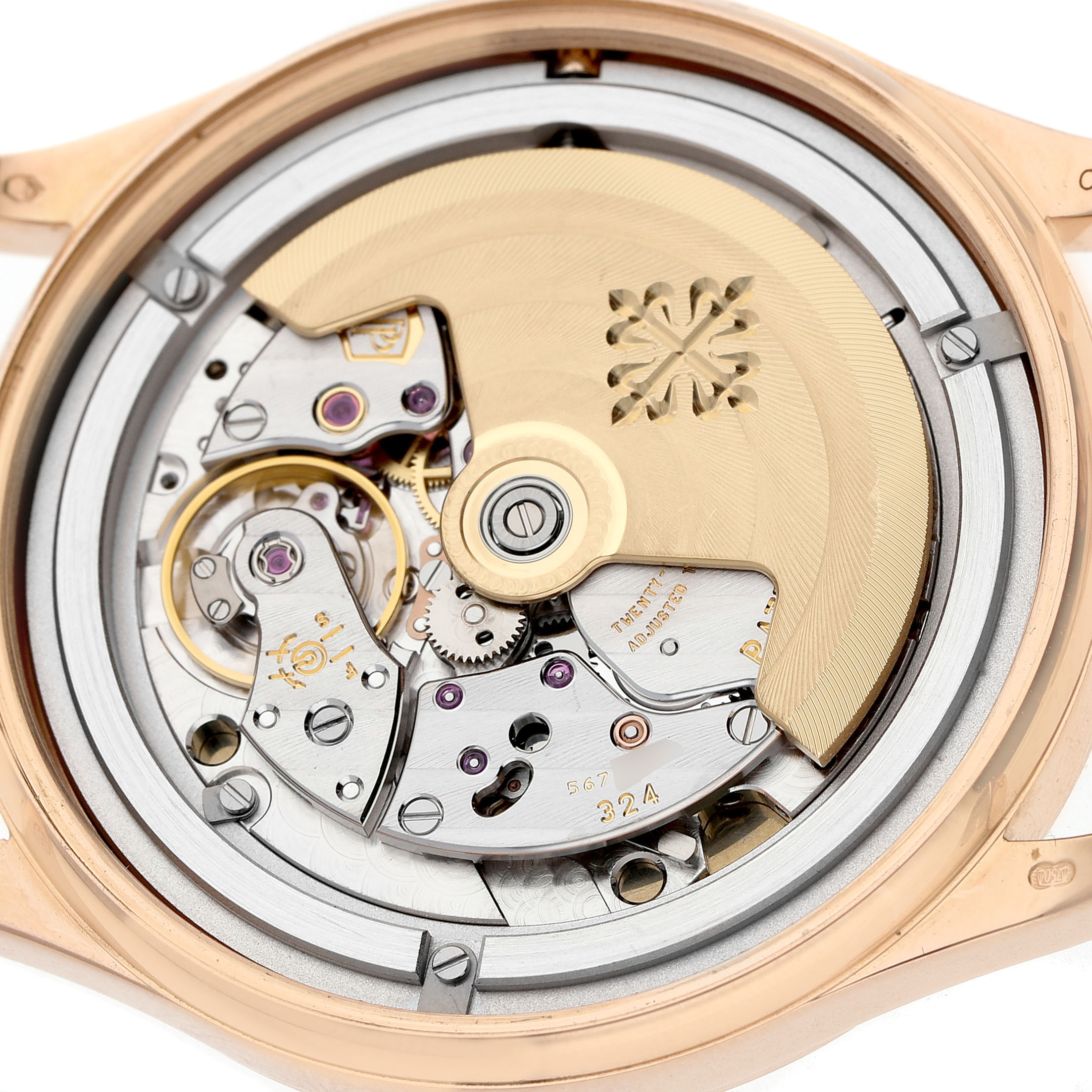 The image shows the back view of a Patek Philippe Calatrava 5296R-010 Men's Rose Gold Silver Dial, highlighting its intricate movement and rotor.