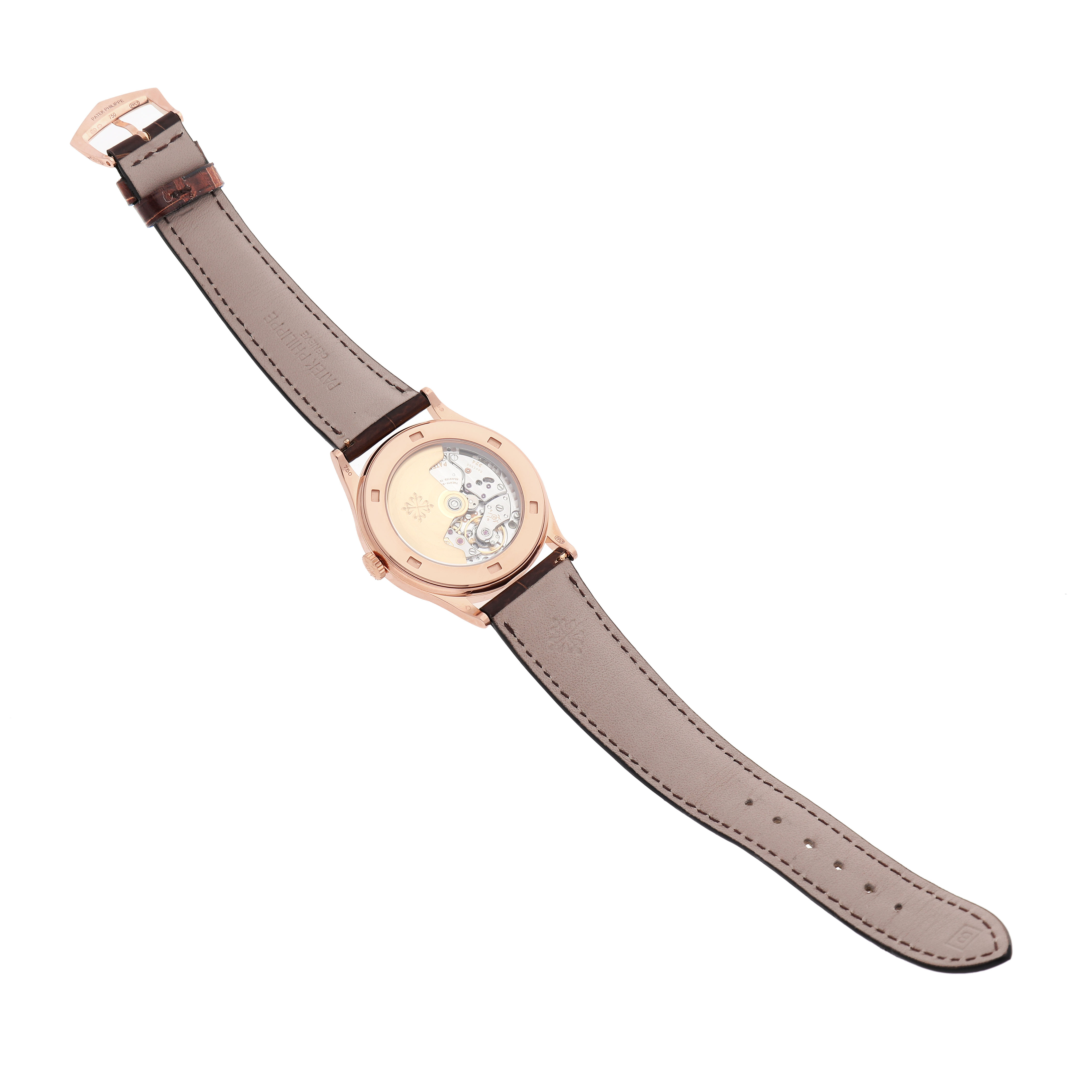 The image shows a Patek Philippe Calatrava 5296R-010 Men's Rose Gold Silver Dial watch from the back, highlighting its leather strap and transparent case back.