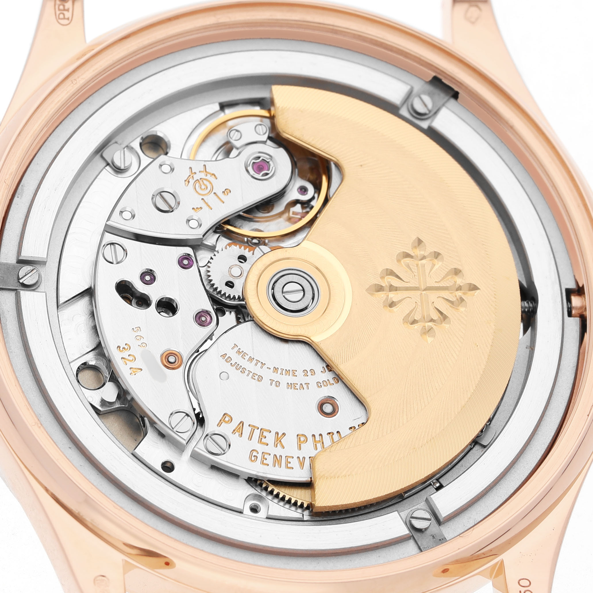 The image shows the movement of a Patek Philippe Calatrava 5296R-010 Men's Rose Gold Silver Dial watch from the back, highlighting the rotor and intricate components.