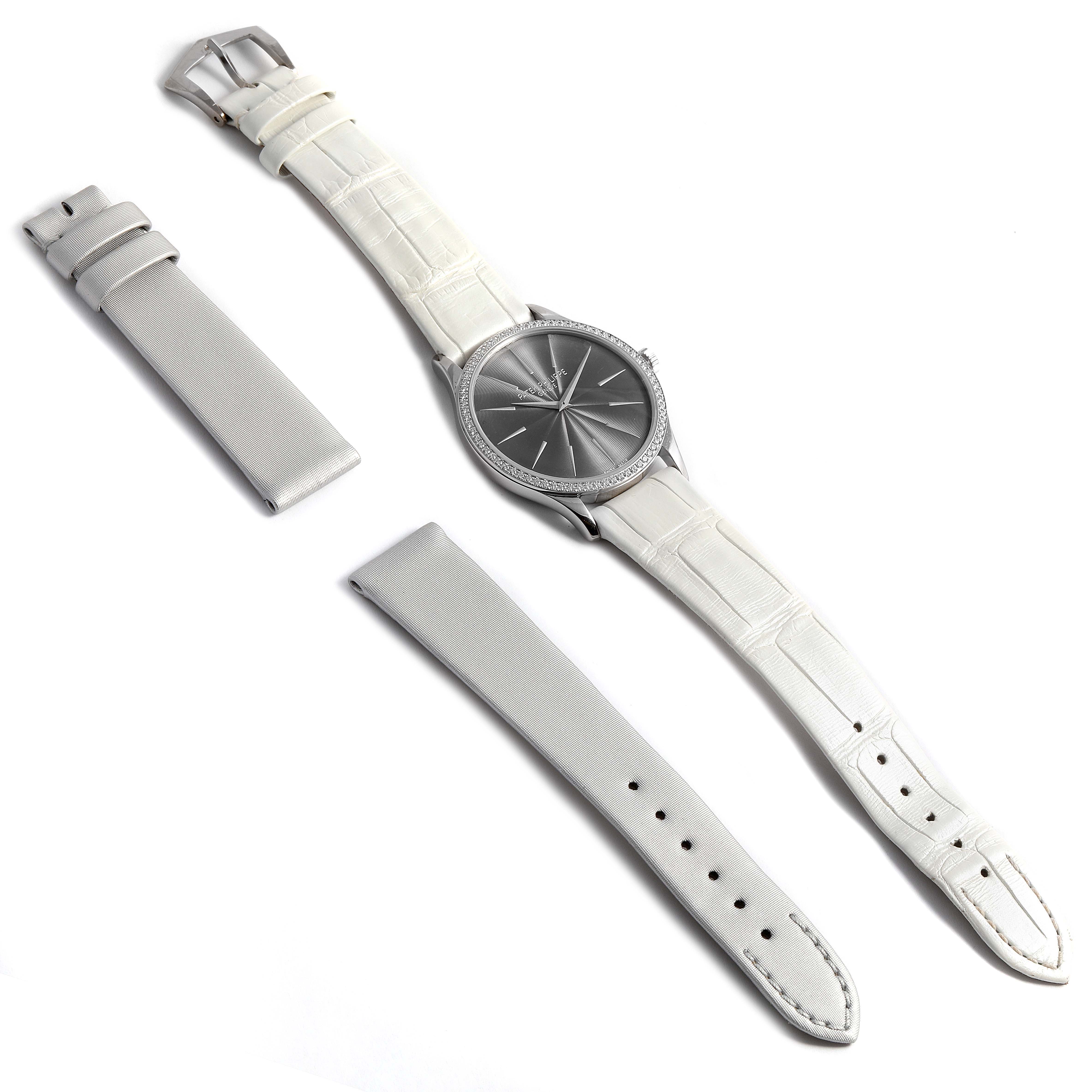 This image shows a Patek Philippe Calatrava 4897G Women's White Gold Silver Dial 4897G Women's White Gold Silver Dial watch from a top-down angle, including its straps and additional strap accessories.
