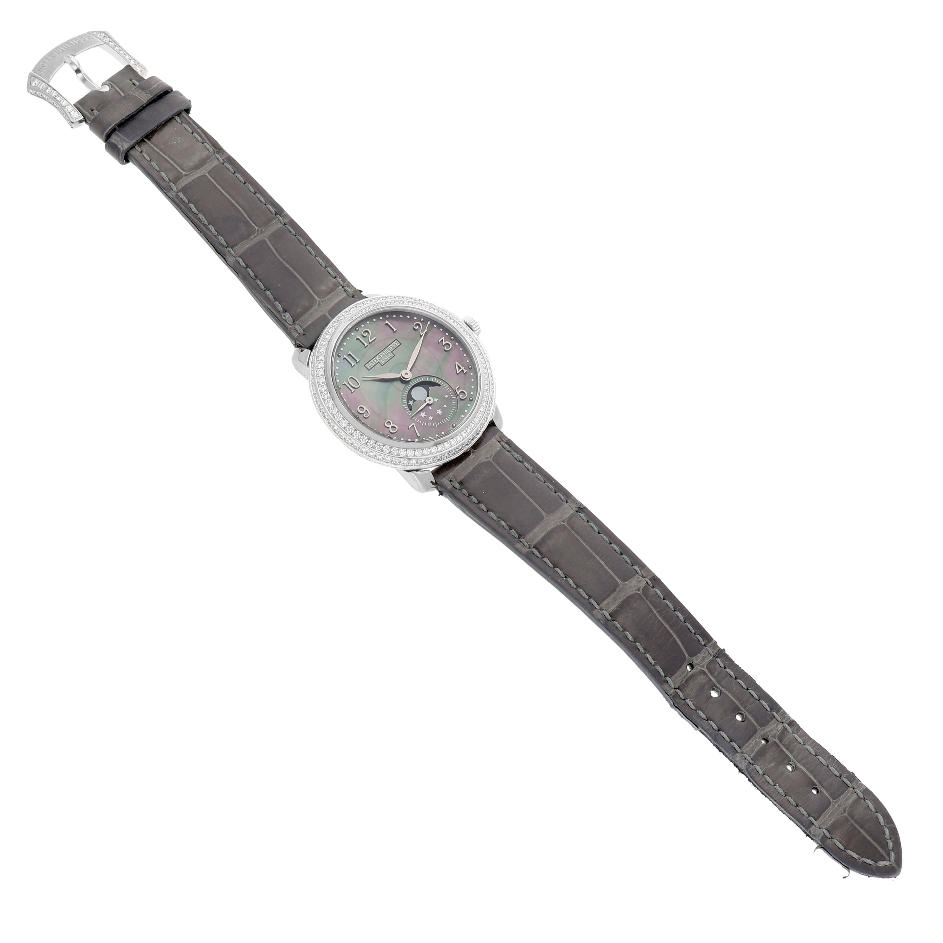 This image shows a top-down view of the Patek Philippe Complications 4968G-001 Women's White Gold Mother of Pearl Dial watch, highlighting the face, band, and buckle.