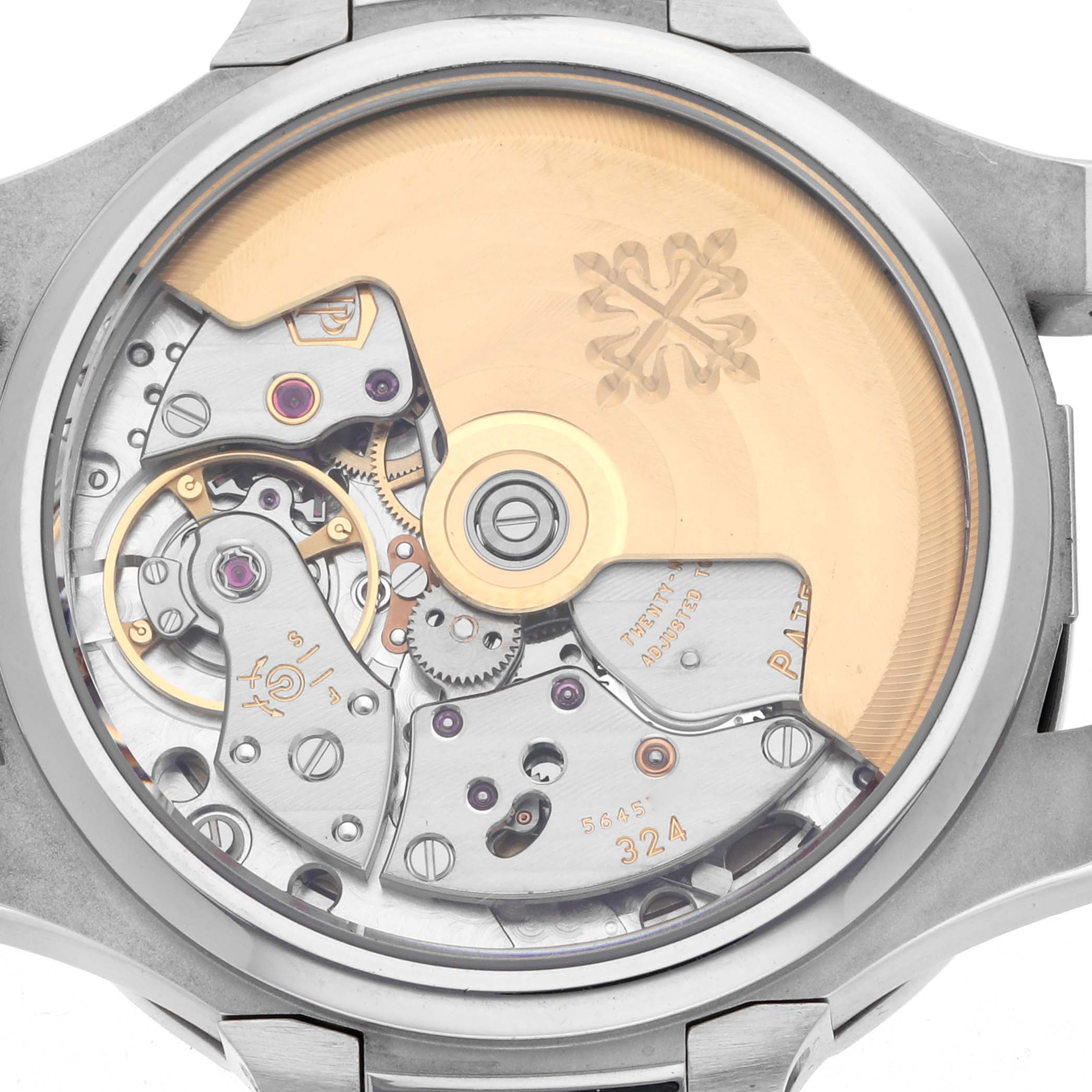 The image shows the back view of a Patek Philippe Nautilus 7008A Women
s Stainless Steel Silver Dial watch, highlighting its intricate movement and rotor.