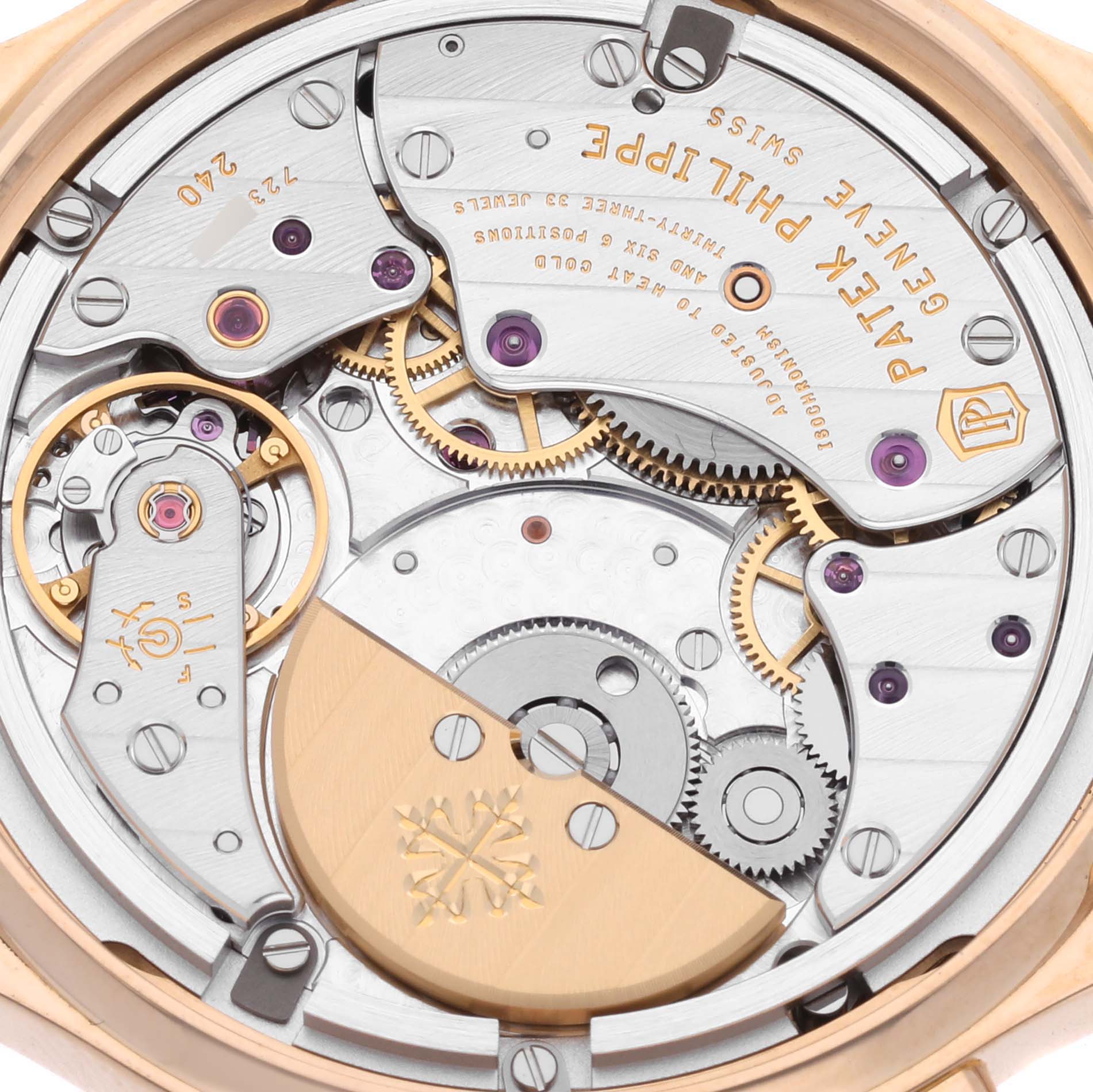 The image shows the intricate movement of a Patek Philippe Complications 7130R-013 Men's Rose Gold Silver Dial watch from a rear angle, highlighting gears and inscriptions.