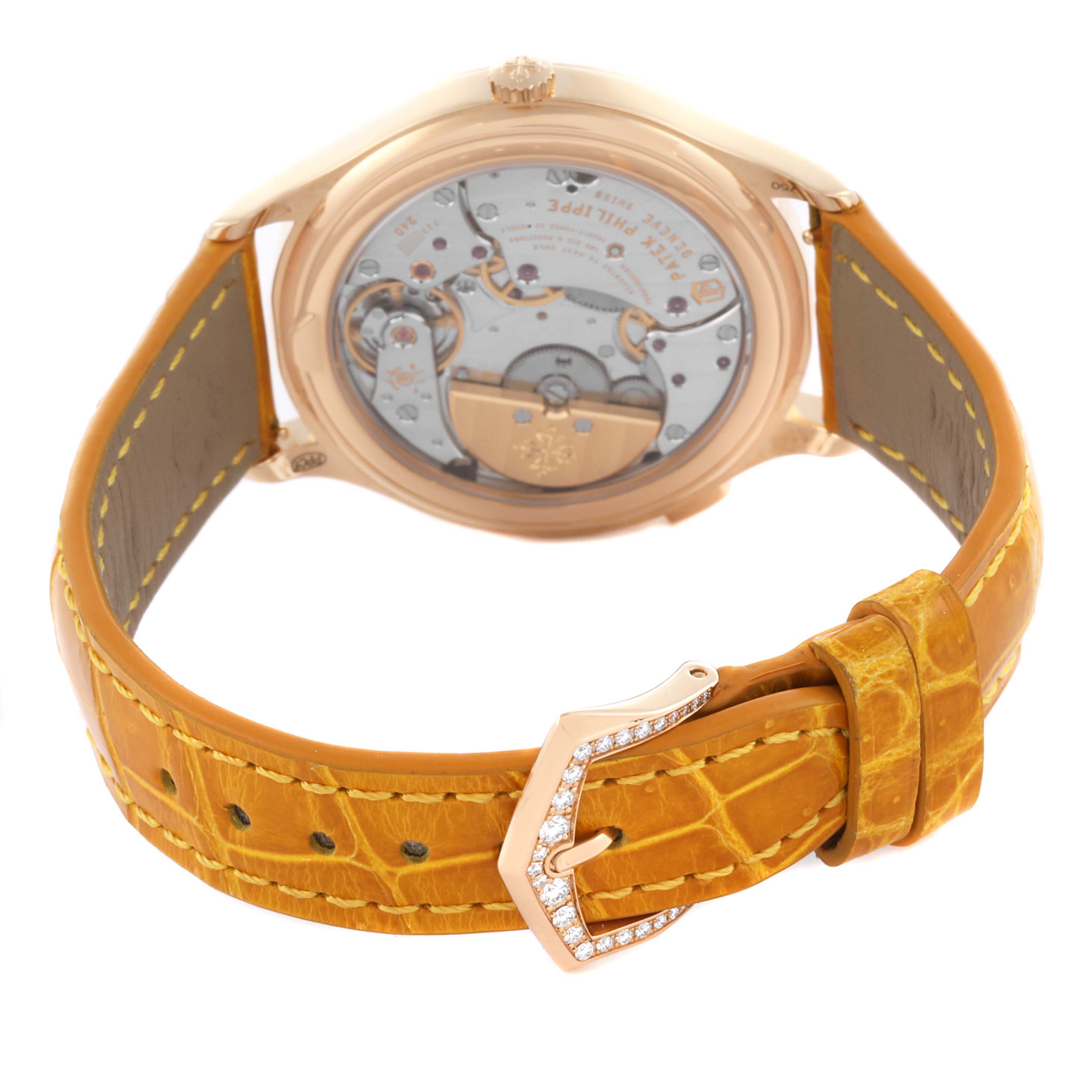 The Patek Philippe Complications 7130R-013 Men's Rose Gold Silver Dial watch is shown from the back, highlighting the movement and yellow leather strap with a jeweled buckle.