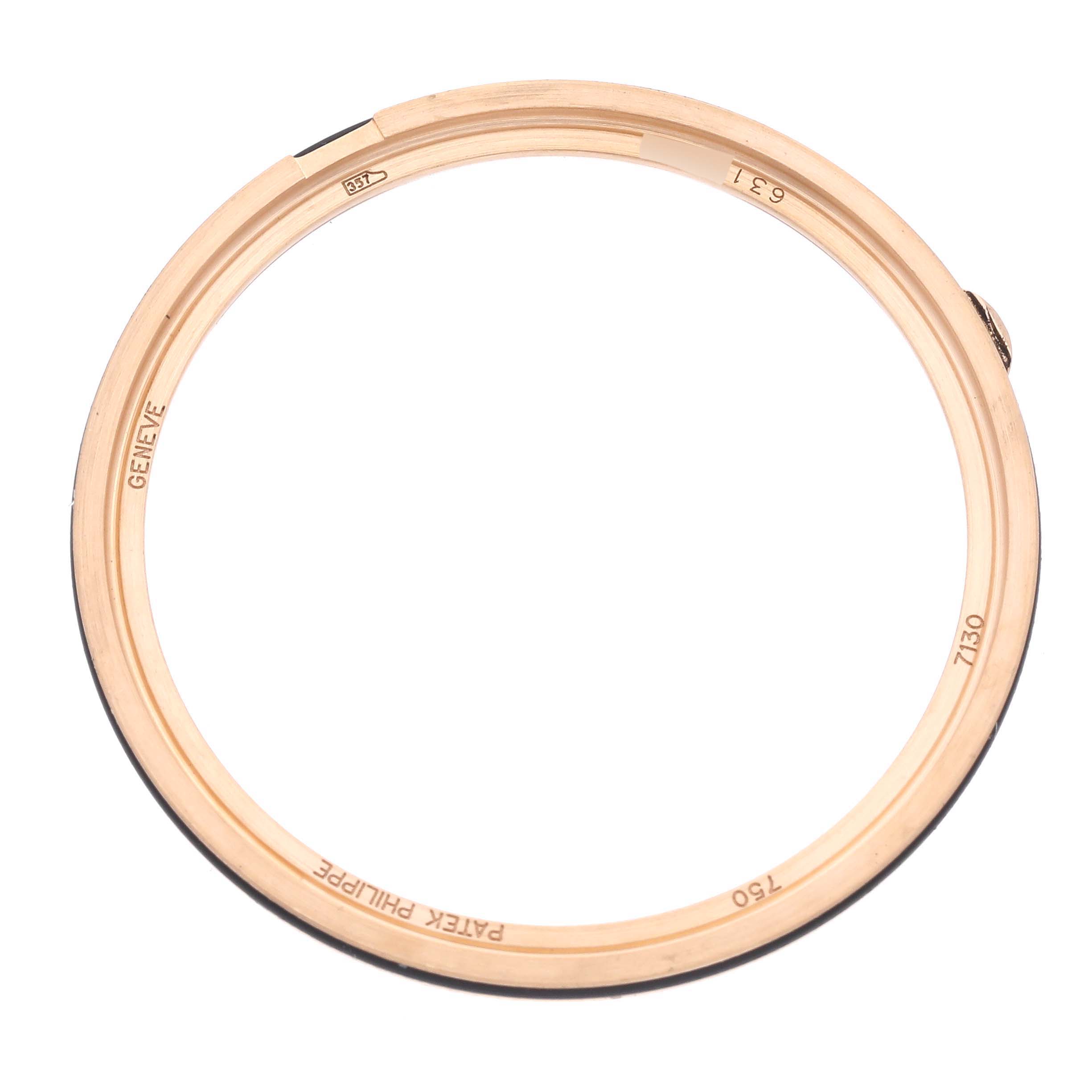 The image shows the bezel of a Patek Philippe Complications 7130R-013 Men's Rose Gold Silver Dial watch, viewed from above, highlighting engravings and details.