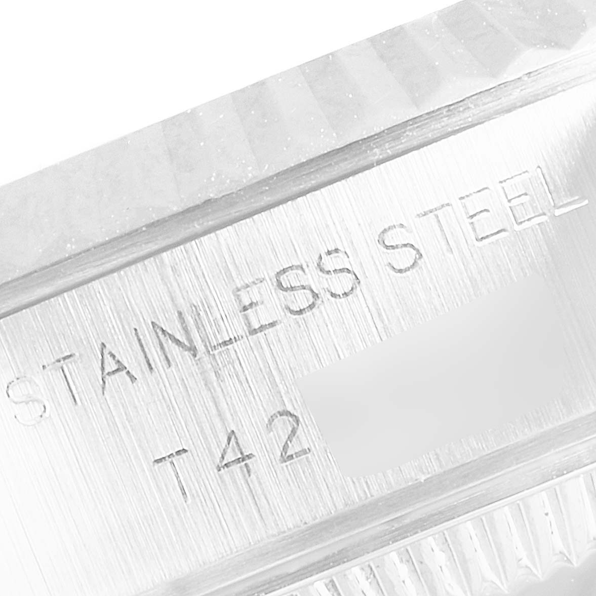 This close-up angle shows the engraved text "STAINLESS STEEL" on the side of a Rolex Datejust 69174 Women's Stainless Steel White Dial 69174 Women's Stainless Steel White Dial watch case.