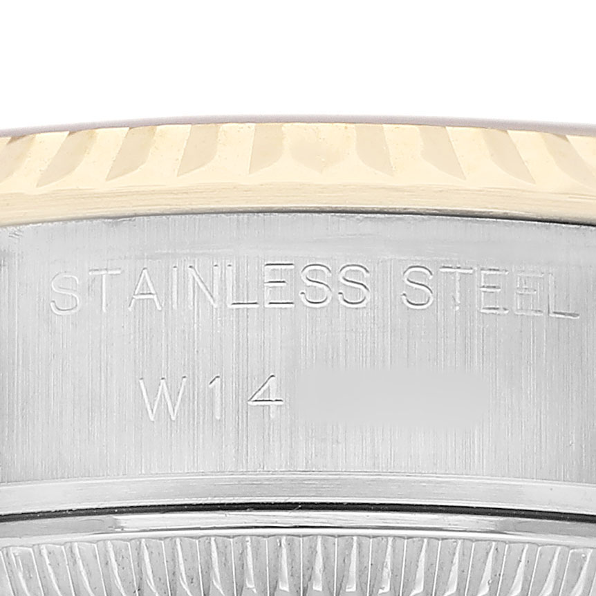 The image shows a close-up of the side of a Rolex Datejust 69173 Women's Steel and Gold (two tone) Champagne Dial watch, highlighting the stainless steel band and markings.