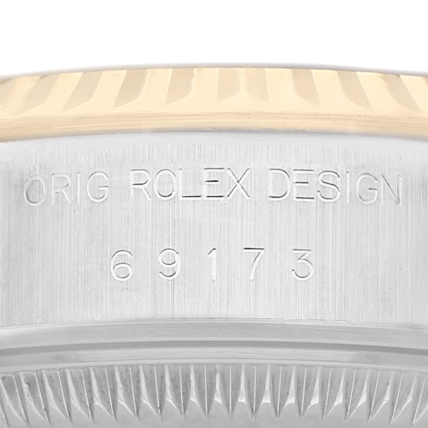 The image shows the side of a Rolex Datejust 69173 Women's Steel and Gold (two tone) Champagne Dial, highlighting the bezel and engraved model number.