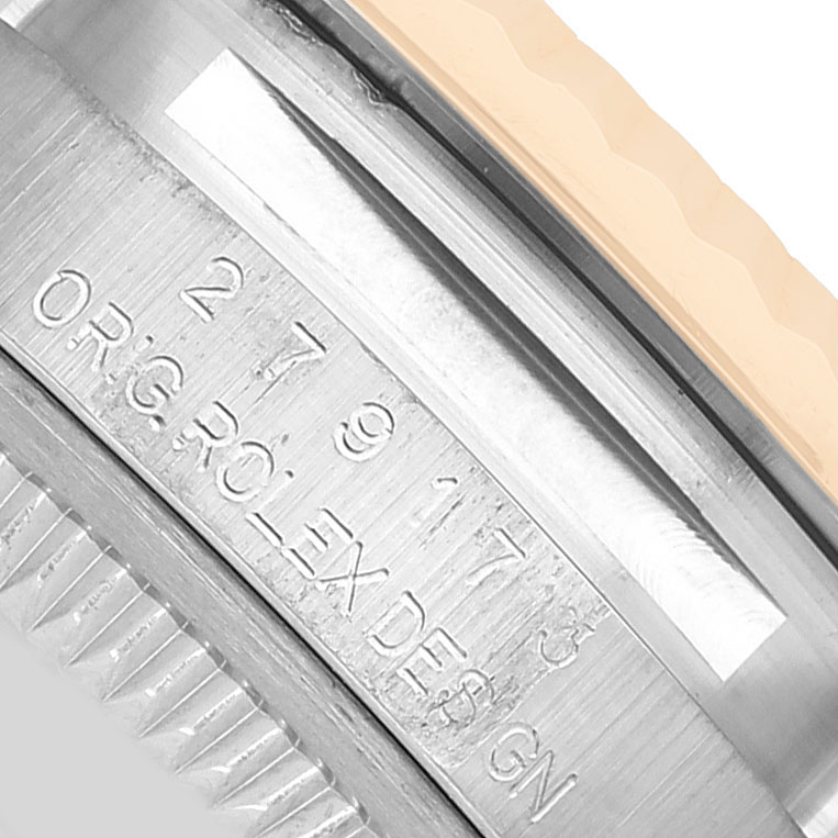 The image shows a close-up angle of the Rolex Datejust 279173 Women's Steel and Gold (two tone) Silver Dial model's side, highlighting the engraved serial number and part of the bezel.