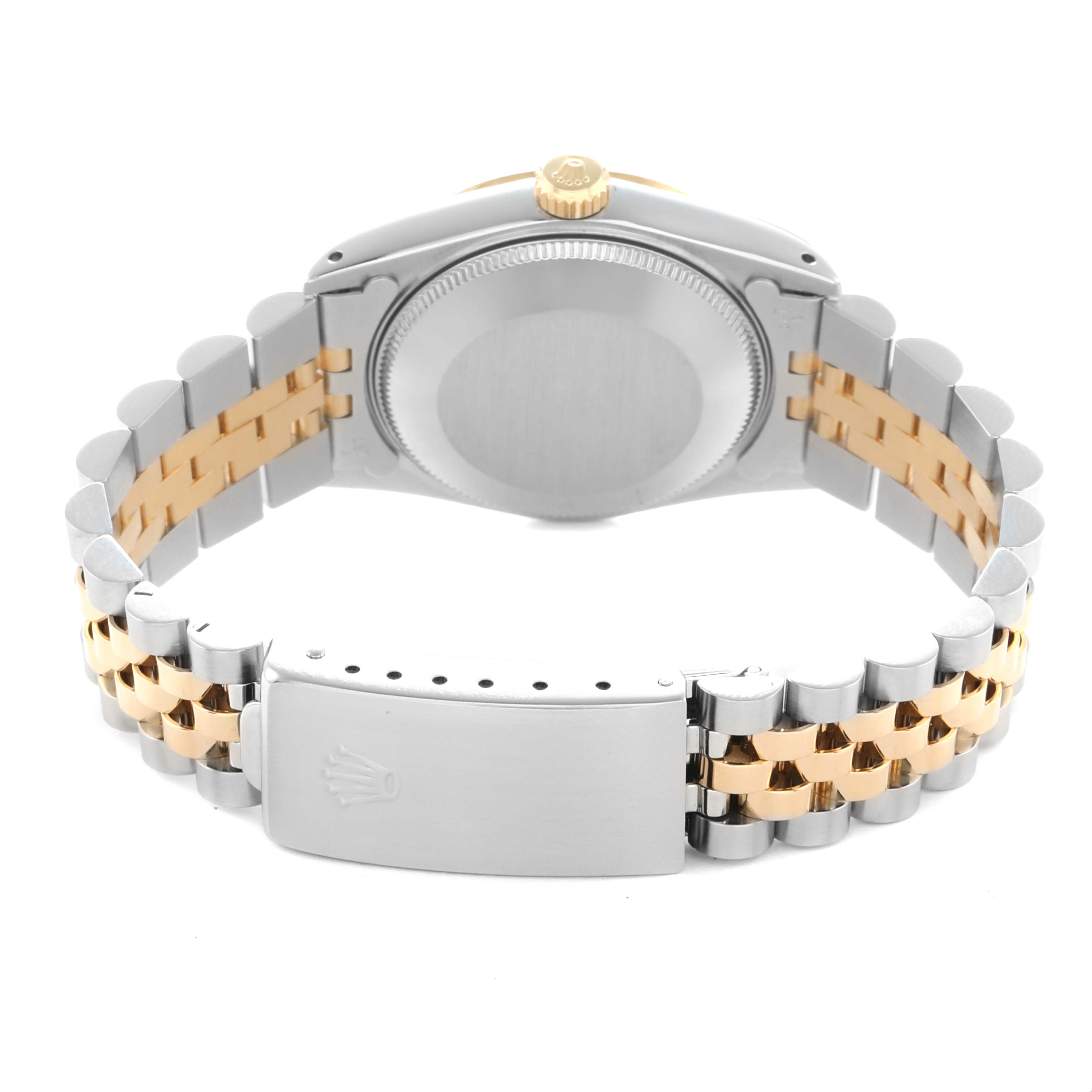The image shows the backside of a Rolex Mid-Size 68273 Women
s Steel and Gold (two tone) Champagne Dial watch, featuring the bracelet, clasp, and case back.