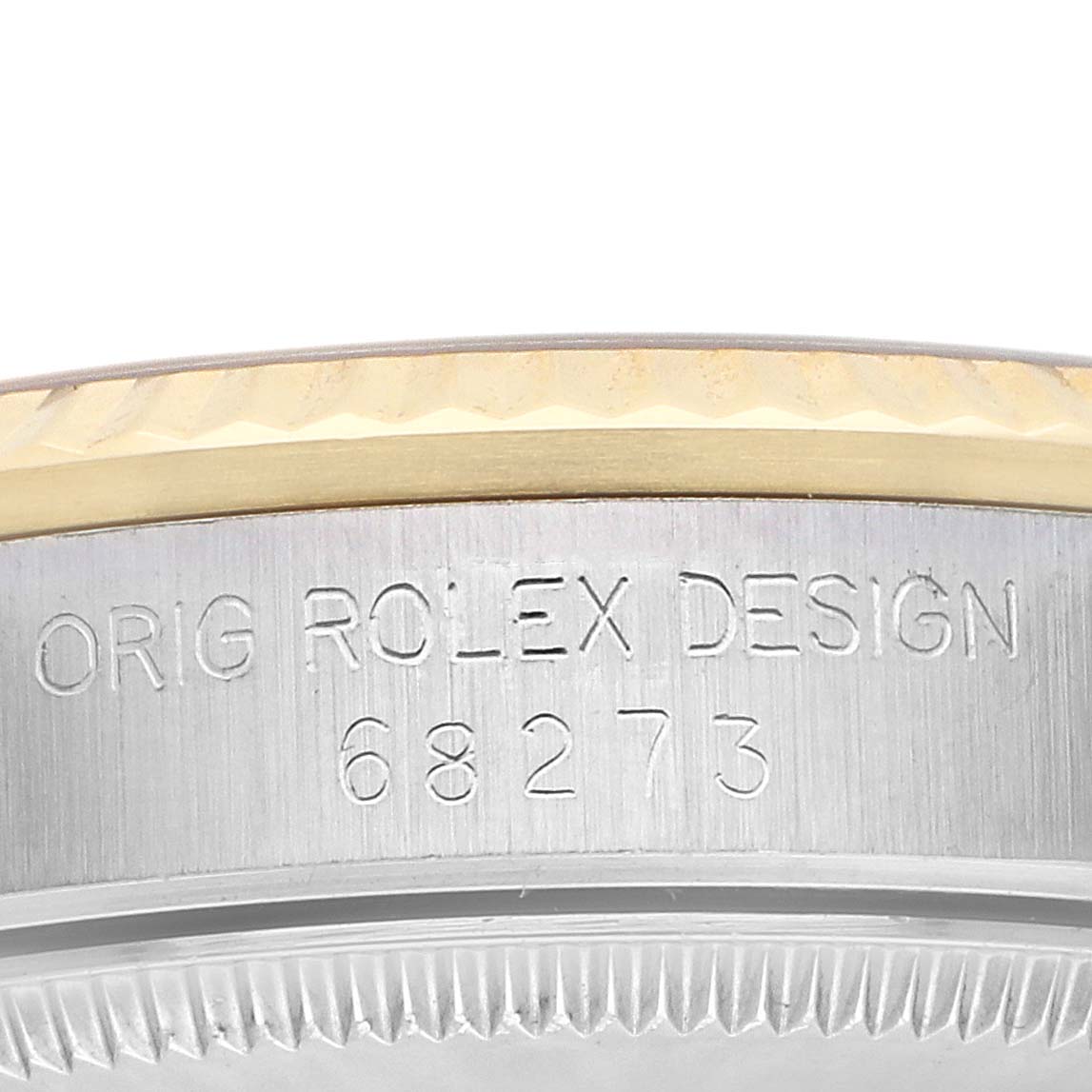 The image shows a close-up of the side engraving and bezel of the Rolex Mid-Size 68273 Women
s Steel and Gold (two tone) Champagne Dial watch, highlighting the model number.
