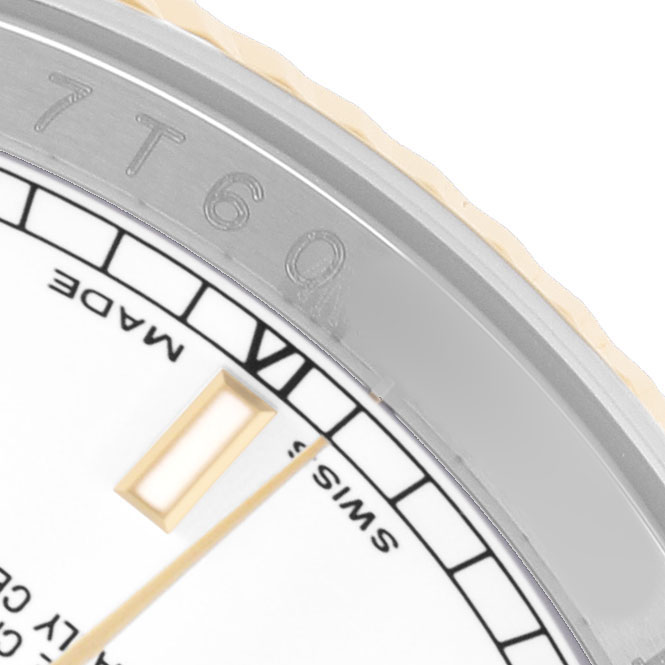 The image shows a close-up of the Rolex Datejust 116233 Men's Steel and Gold (two tone) White Dial watch's bezel and a portion of the dial with hour markers.