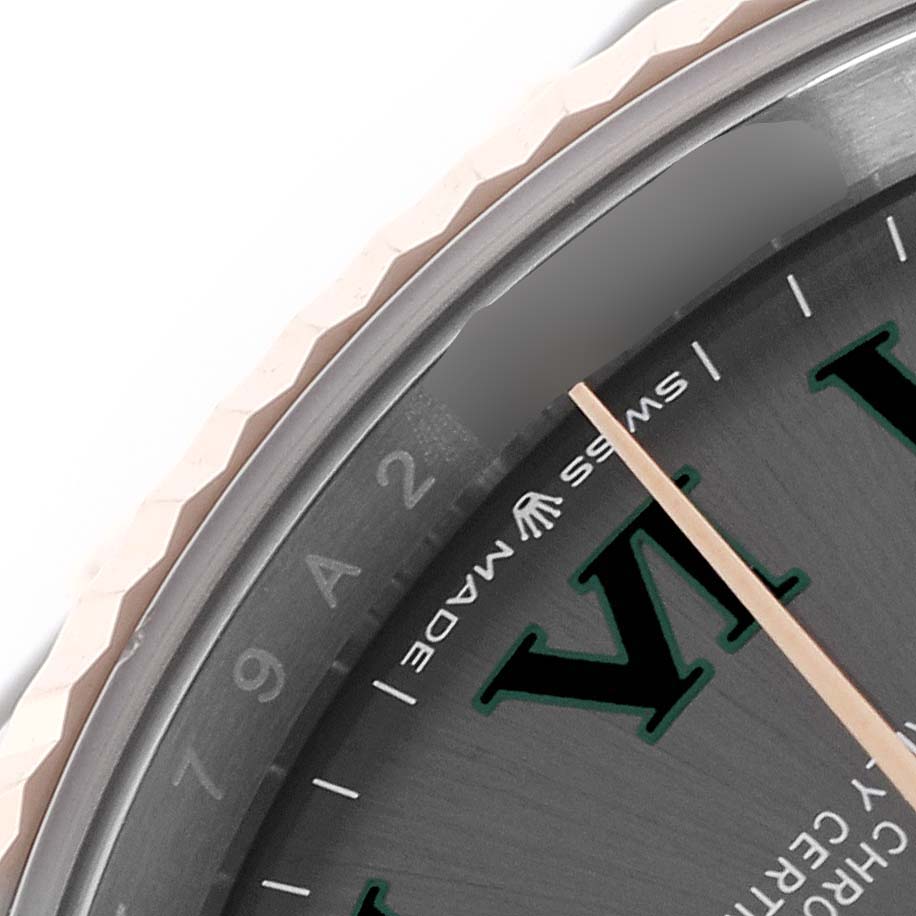 The image shows a close-up of the Rolex Datejust 126231 Men's Steel and Gold (two tone) Grey Dial 126231 Men's Steel and Gold (two tone) Grey Dial watch's bezel and partial dial, featuring a textured edge and Roman numeral markers.