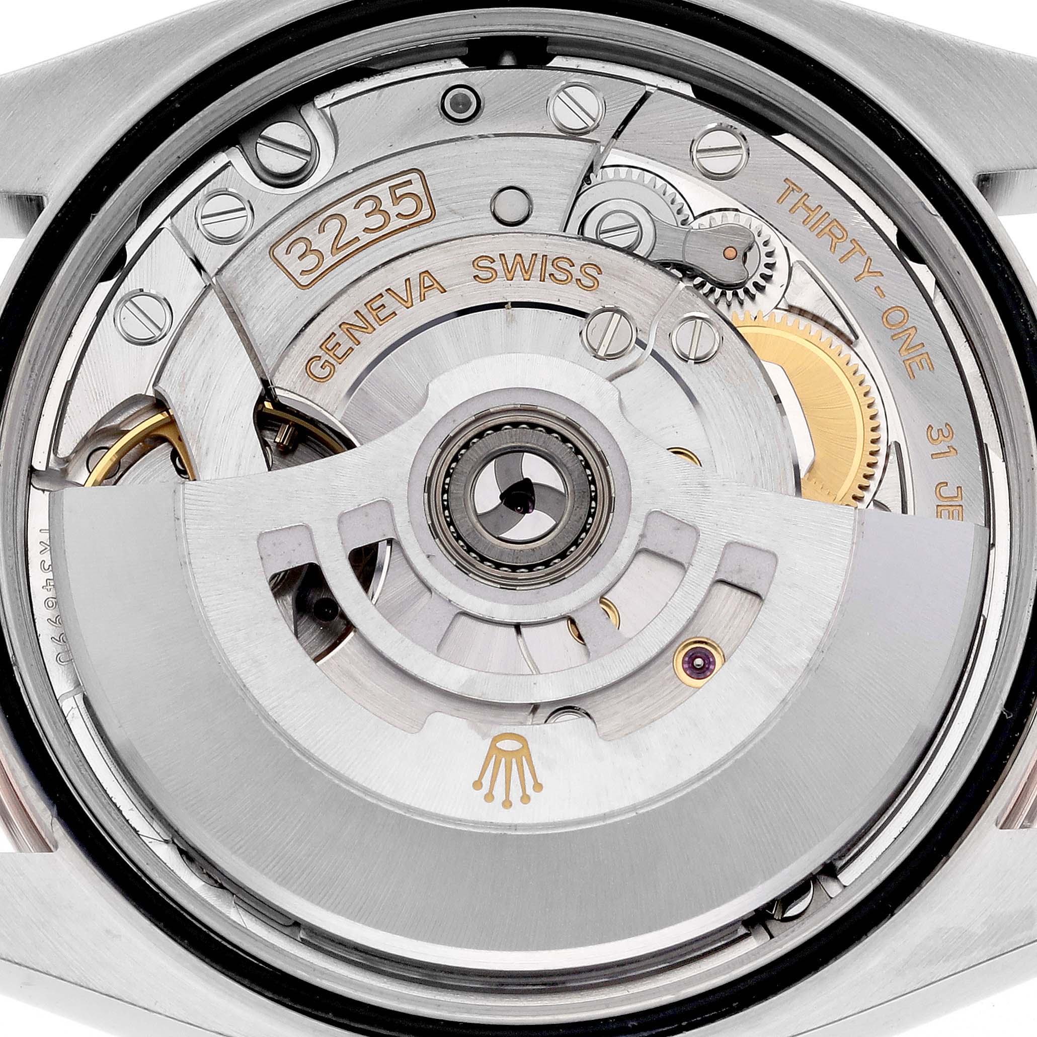 The image shows the movement of a Rolex Datejust 126231 Men's Steel and Gold (two tone) Grey Dial 126231 Men's Steel and Gold (two tone) Grey Dial watch from a rear angle, highlighting internal mechanisms and engravings.