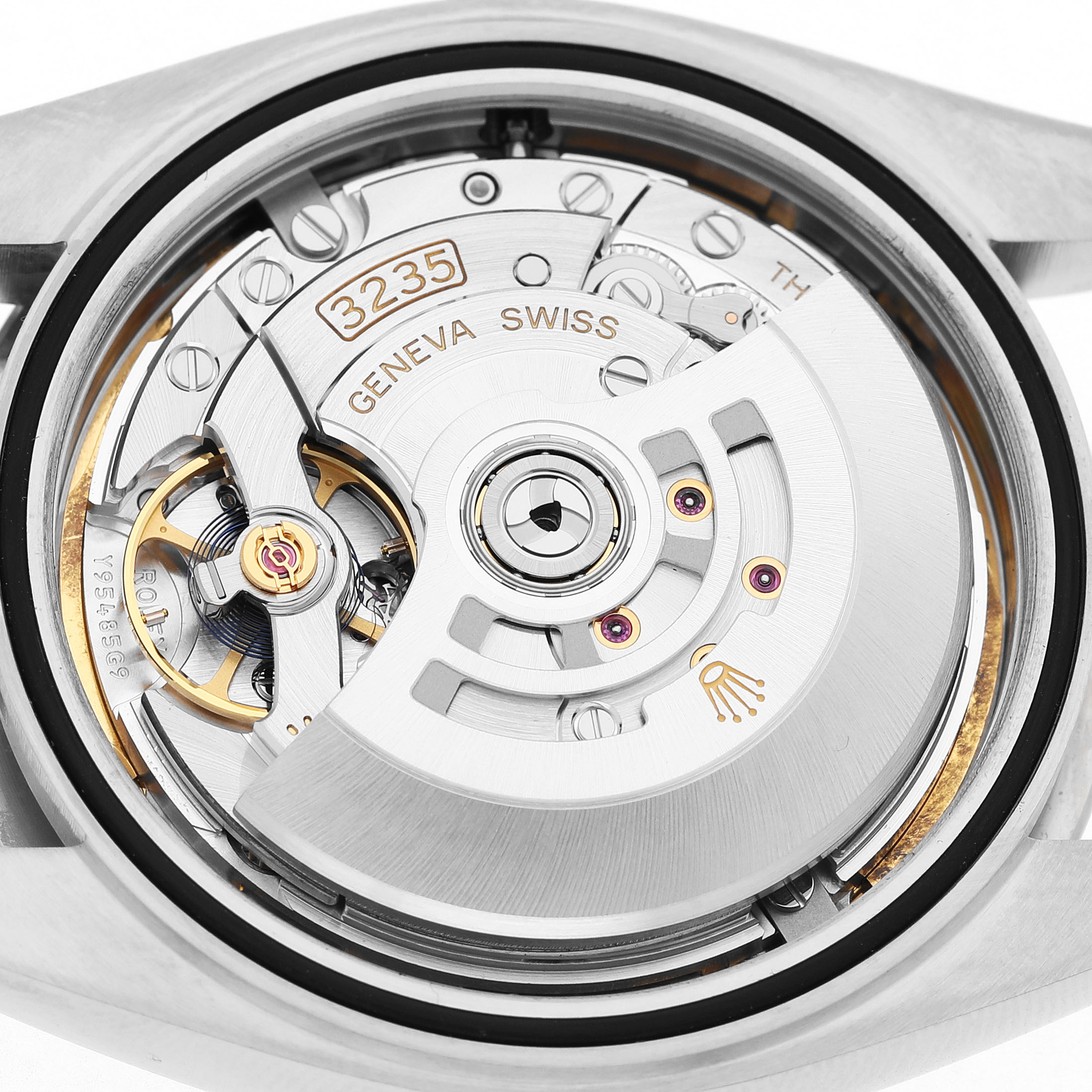 The image shows the movement mechanism of a Rolex Datejust 41 126334 Men's Stainless Steel Blue Dial, highlighting the rotor and intricate gears.