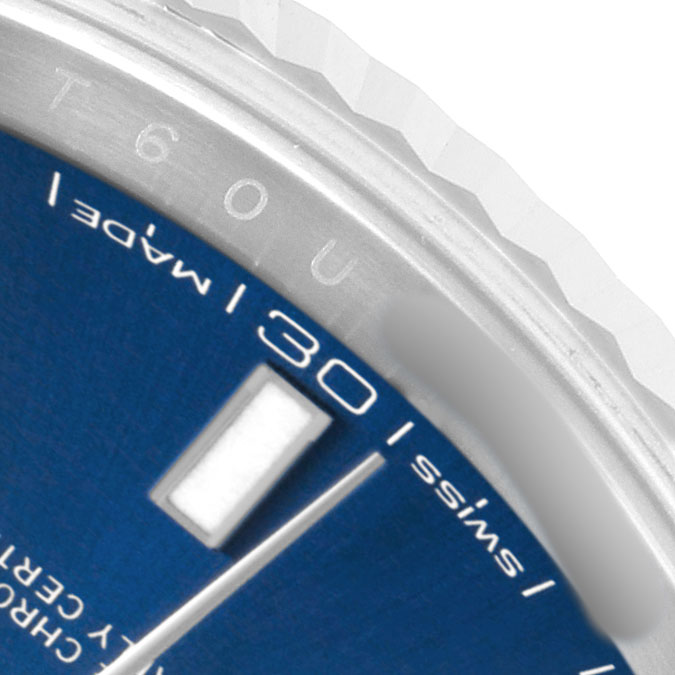 The image shows a close-up of the Rolex Datejust 41 126334 Men's Stainless Steel Blue Dial's blue dial, bezel, and part of the hour marker at an oblique angle.