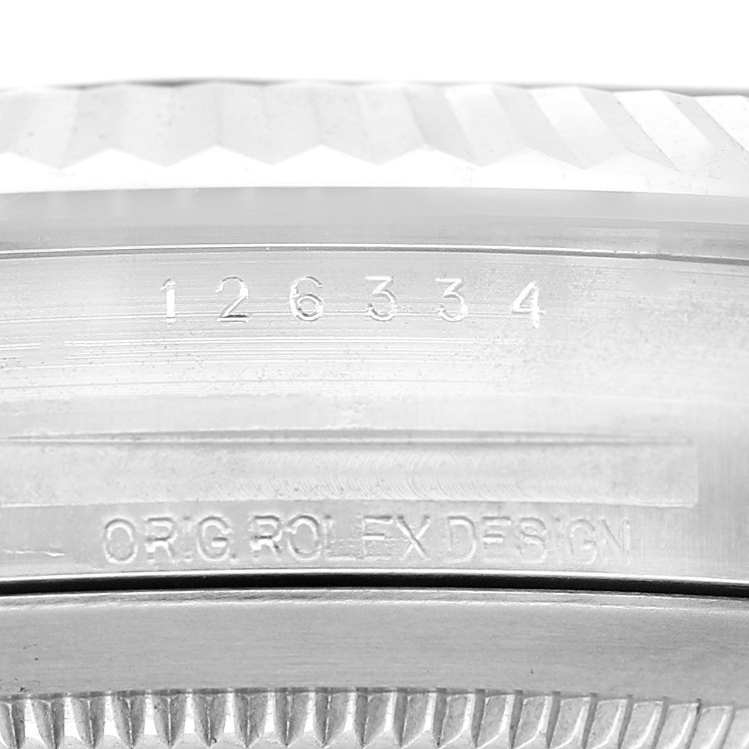 The image shows a close-up of the engraved edge and inner bezel of a Rolex Datejust 41 126334 Men's Stainless Steel Silver Dial.
