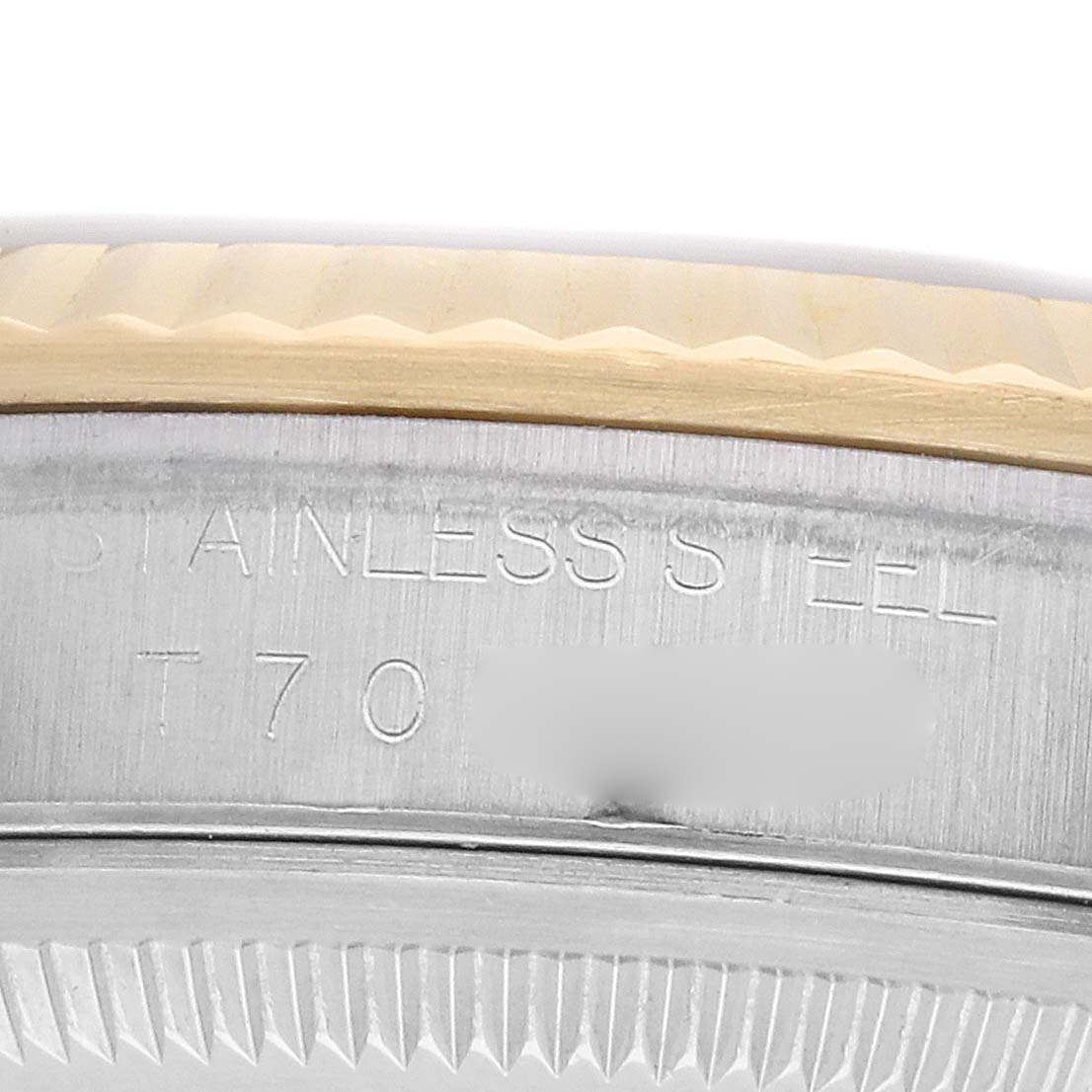 The image shows a close-up of the side engraving on the stainless steel case of the Rolex Datejust 16233 Men
s Steel and Gold (two tone) Champagne Dial, featuring part of the bezel.