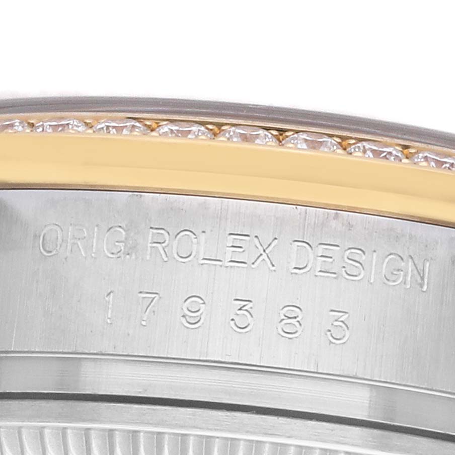 The image shows a side view of the Rolex Datejust 179383 Women
s Steel and Gold (two tone) Champagne Dial, featuring its engraved case edge and diamond-set bezel.