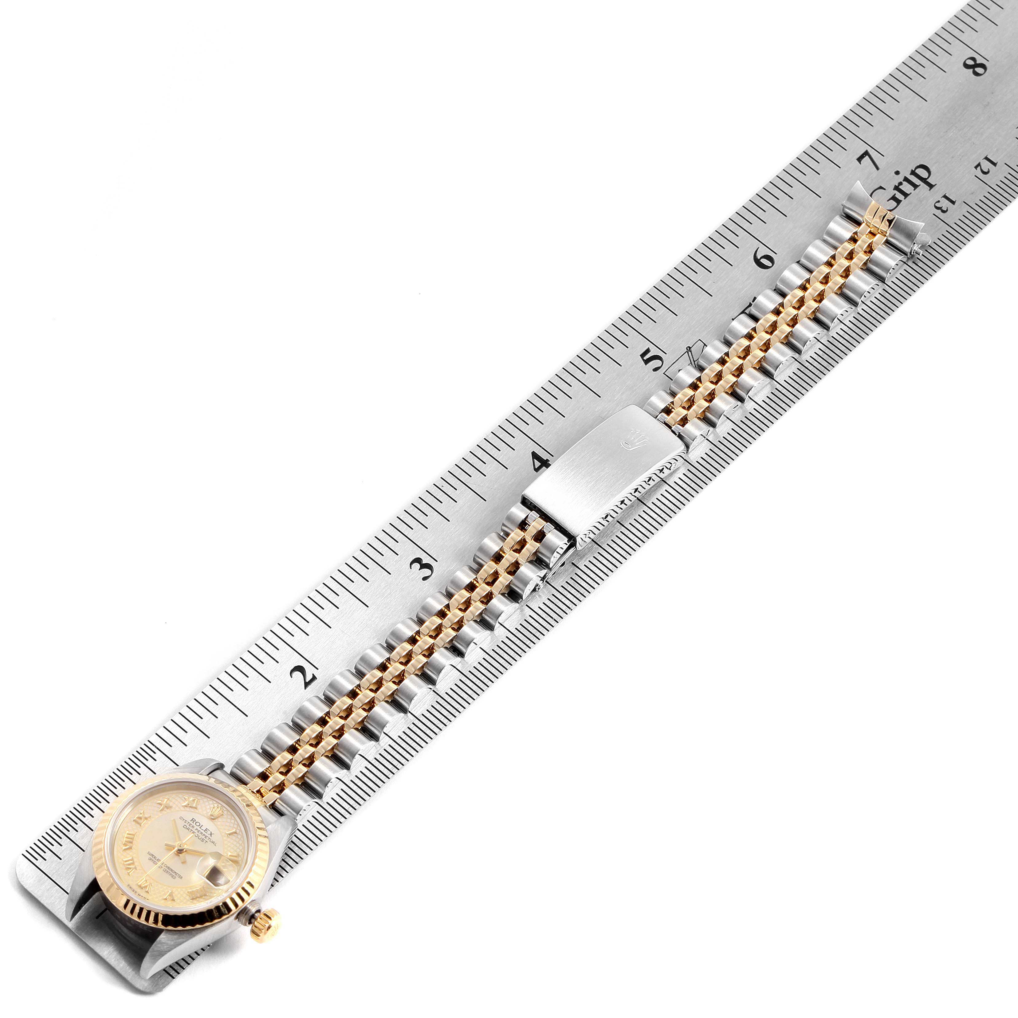 The image shows a Rolex Datejust 79173 Women's Yellow Gold Mother of Pearl Dial 79173 Women's Yellow Gold Mother of Pearl Dial watch lying flat against a ruler, highlighting the face, crown, and bracelet.