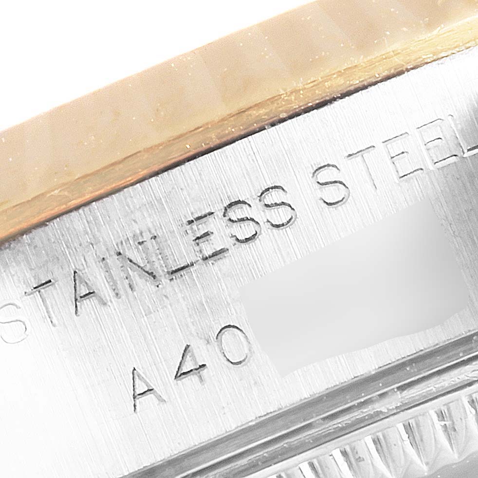 The image shows a close-up of the side of a Rolex Datejust 79173 Women's Yellow Gold Mother of Pearl Dial 79173 Women's Yellow Gold Mother of Pearl Dial watch, revealing the "STAINLESS STEEL" engraving on the case.