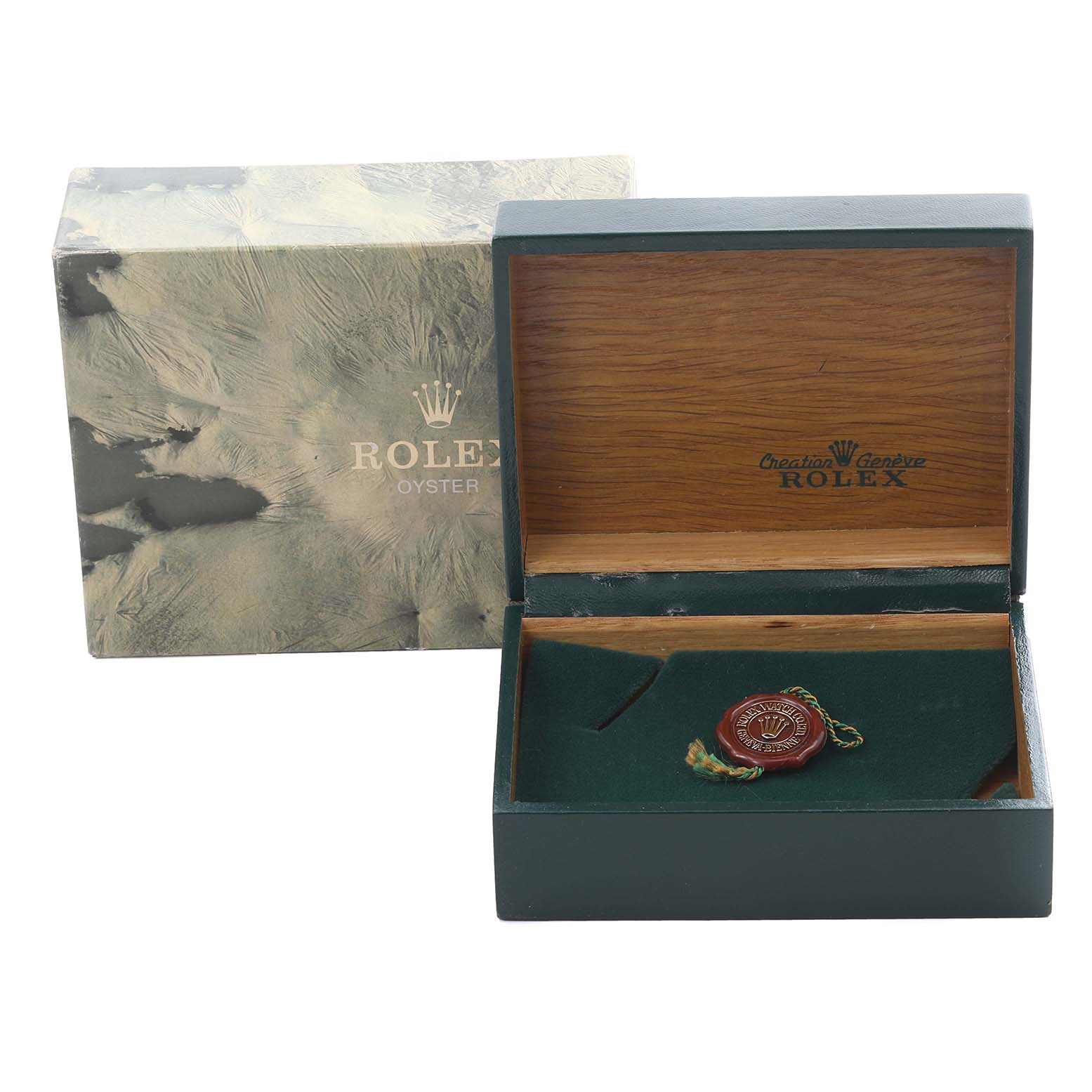 The image shows a vintage Rolex box with the lid open, featuring the Rolex Oyster branding and a vintage medallion.
