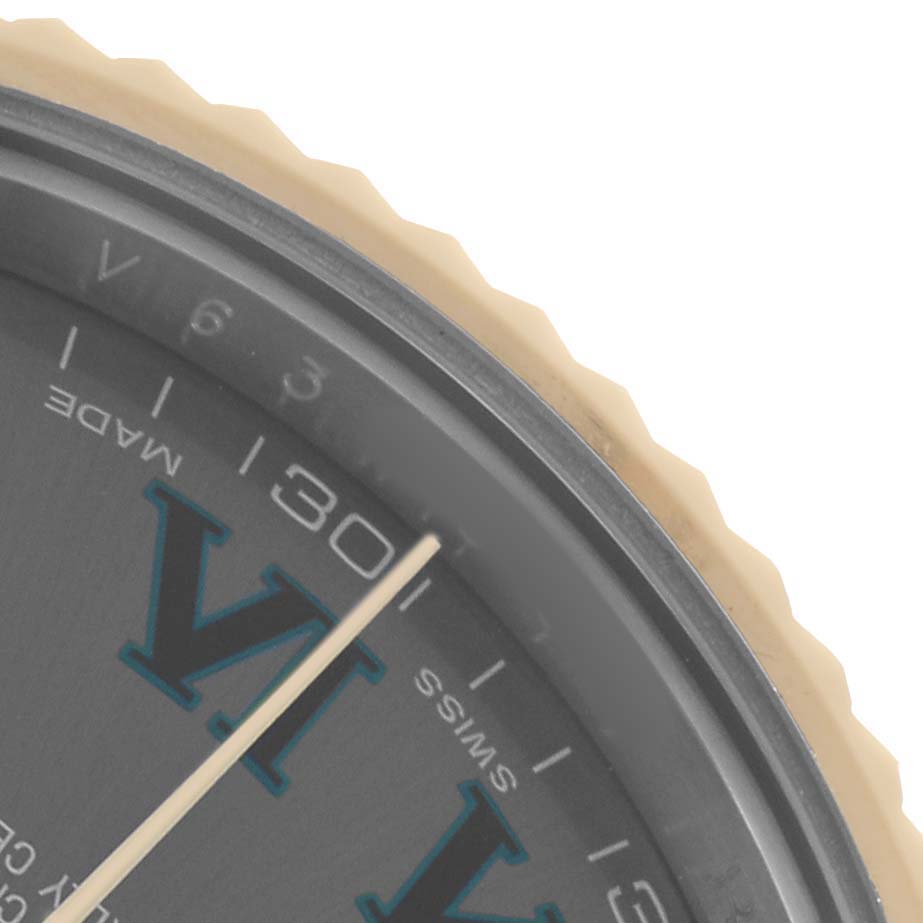The image shows a close-up of the Rolex Datejust 41 116333 Men
s Steel and Gold (two tone) Silver Dial dial with part of the bezel and Roman numeral.
