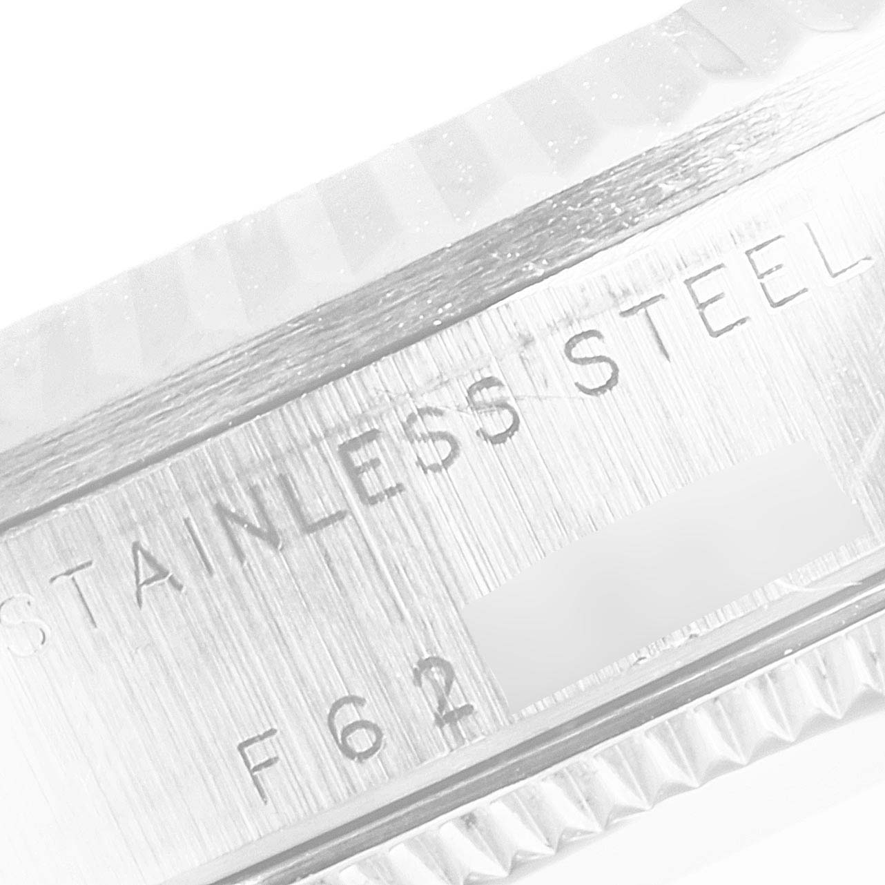 The image shows a close-up of the stainless steel casing of a Mid-Size Rolex watch.