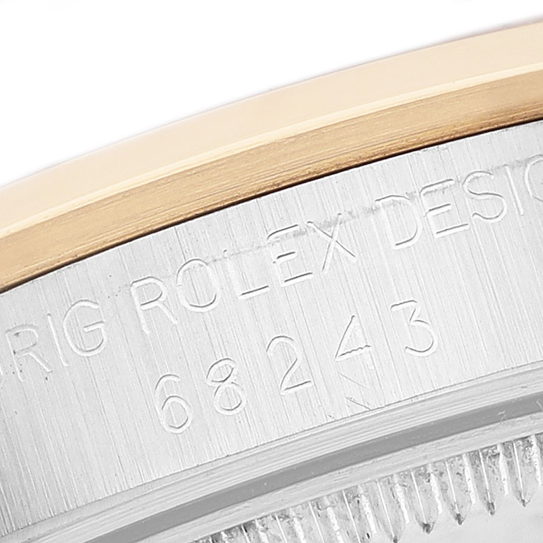 The image shows a close-up of the case side with engravings on a Rolex Datejust 68243 Women's Steel and Gold (two tone) Blue Dial watch.