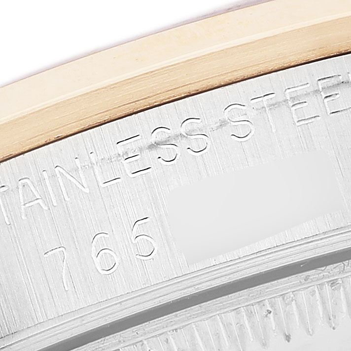 The image shows a close-up of the case back edge and the engraving on a Rolex Datejust 68243 Women's Steel and Gold (two tone) Blue Dial, highlighting the "STAINLESS STEEL" text.