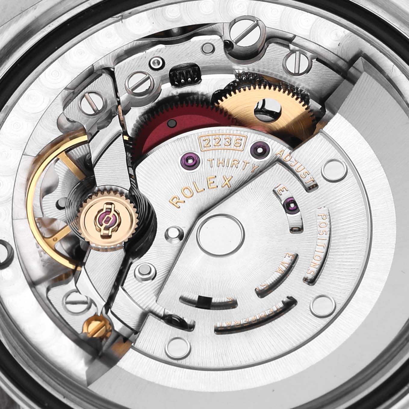 The image shows the internal movement of a Mid-Size Rolex watch from a top-down angle, highlighting gears and components.